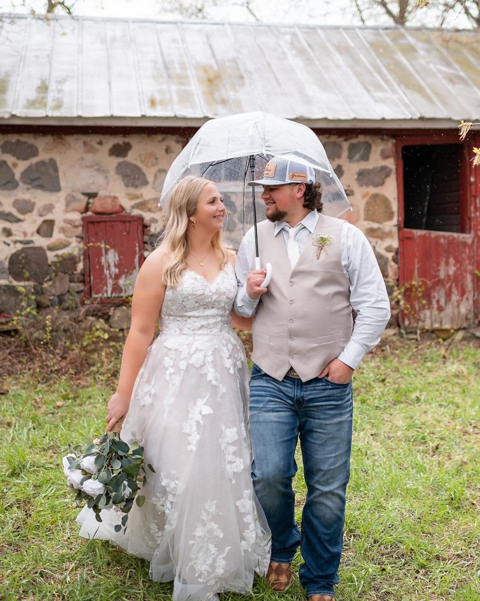 There must be something about this time of year that calls for rain!

This time last year, we celebrated these two tying the knot as the rain came down and here we are year later with rain in the forecast. But as they say, rain on your wedding day ma