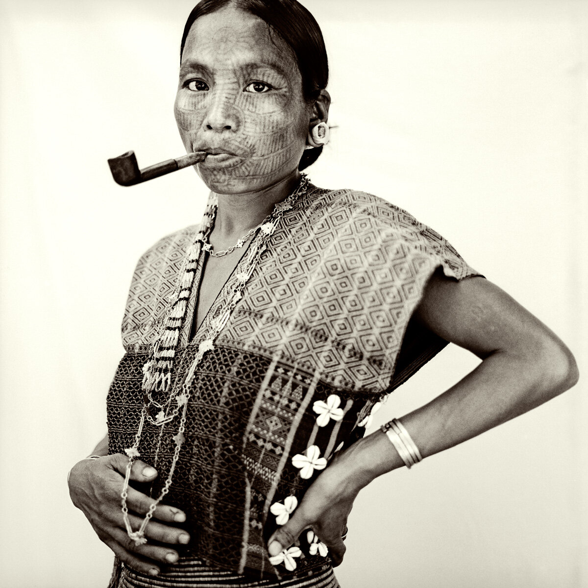Pipe-smoking Laytu Chin in traditional attire