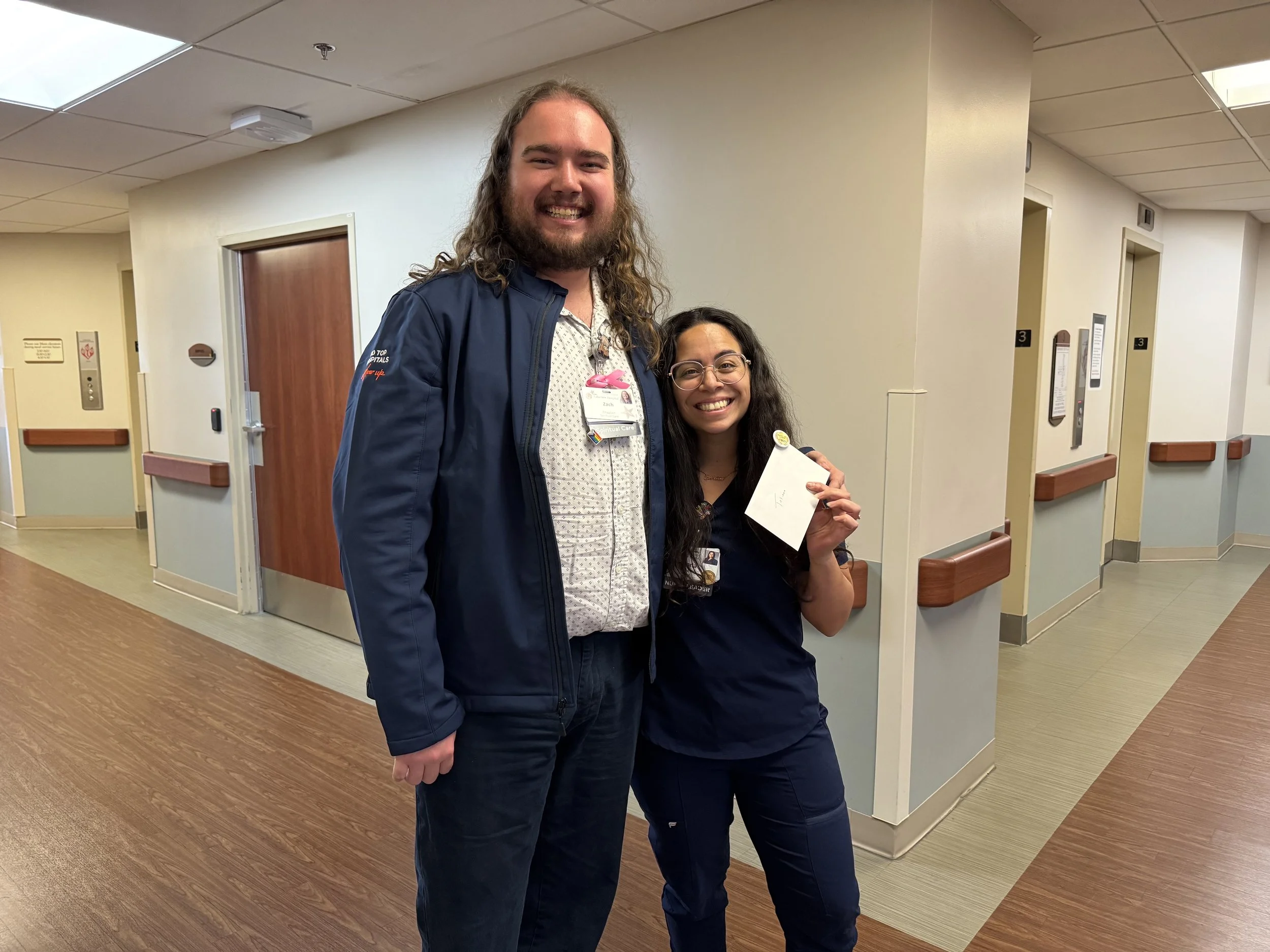 Chaplain Manager Zach Plants celebrates Lakeview Hospital RN Tatiana Pepesulates 