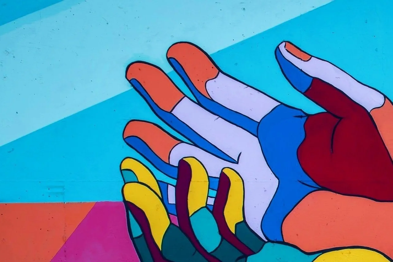 Colorful abstract painting of hands on a blue background