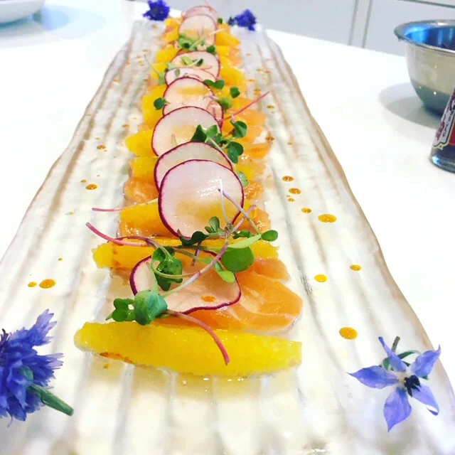 Salmon Sashimi, cucumber, radish, oranges in a yuzu ponzu sauce