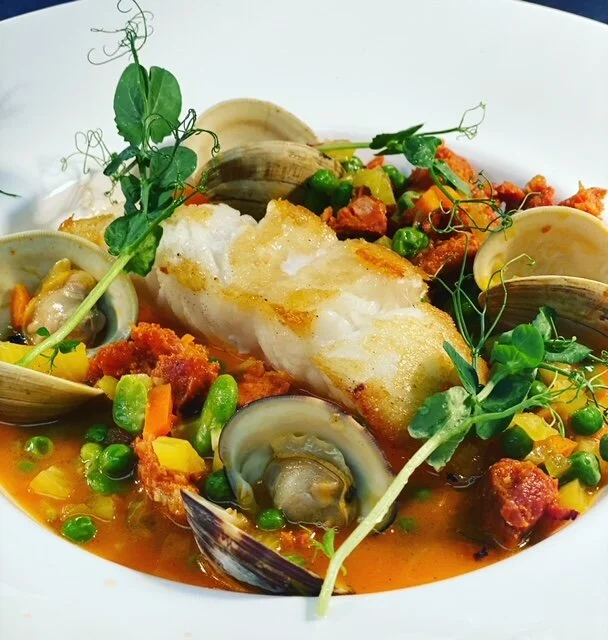 Sea Bass with clams in a chorizo fennel tomato saffron broth