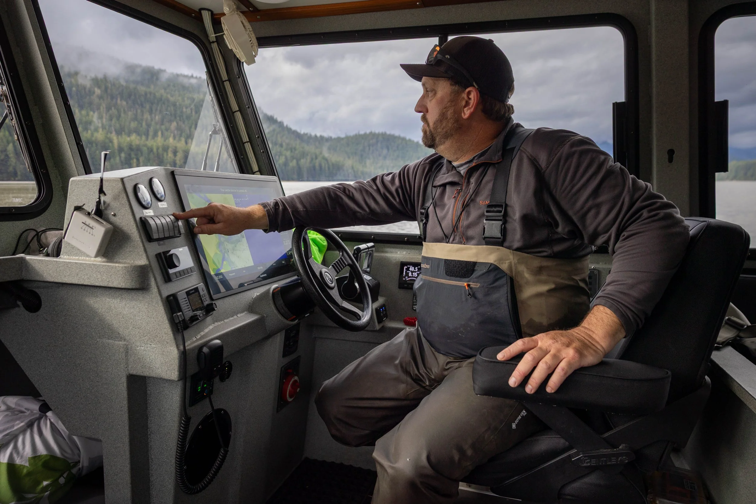 Rick Matney, Chrome Chasers owner and head guide, at the helm of the Chromagnum in Southeast Alaska's Tongass National Forest