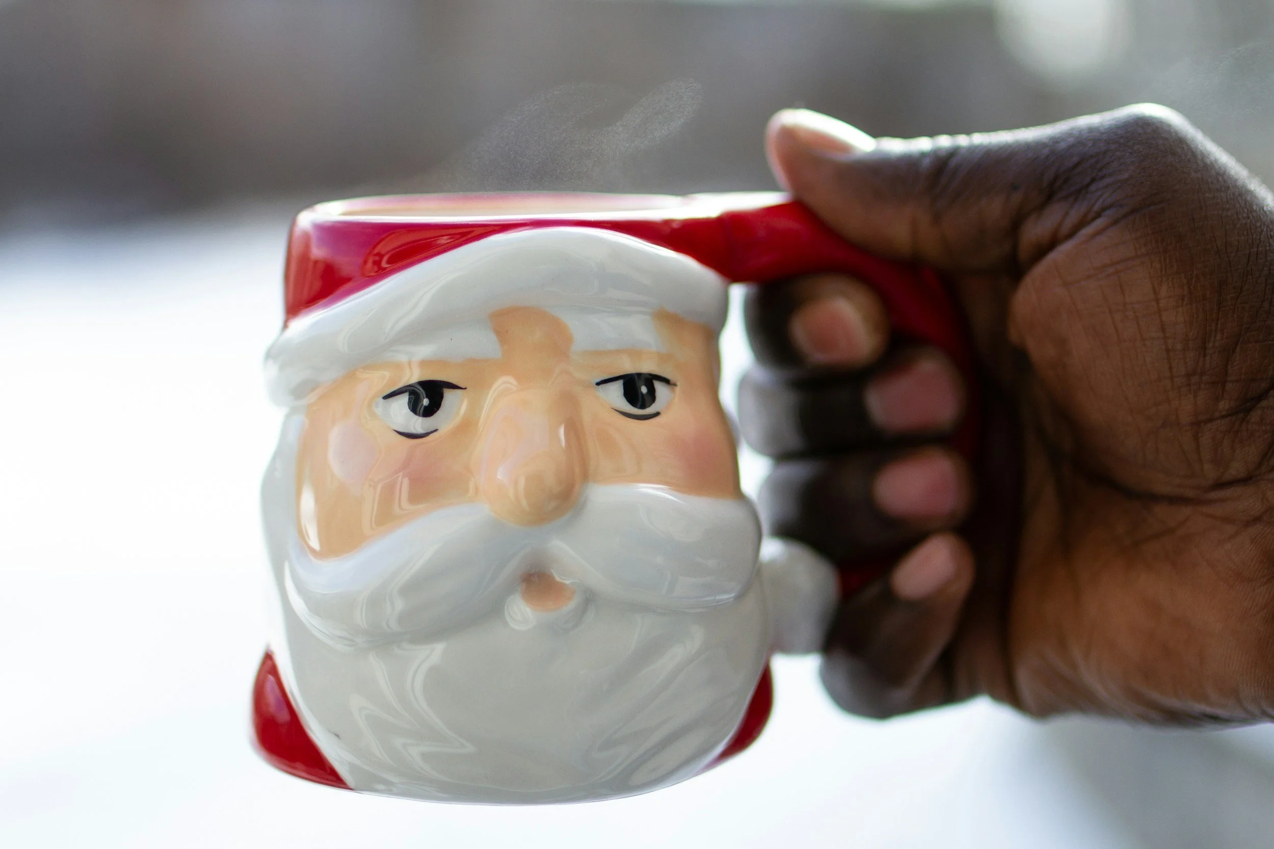 man holding Santa coffee cup