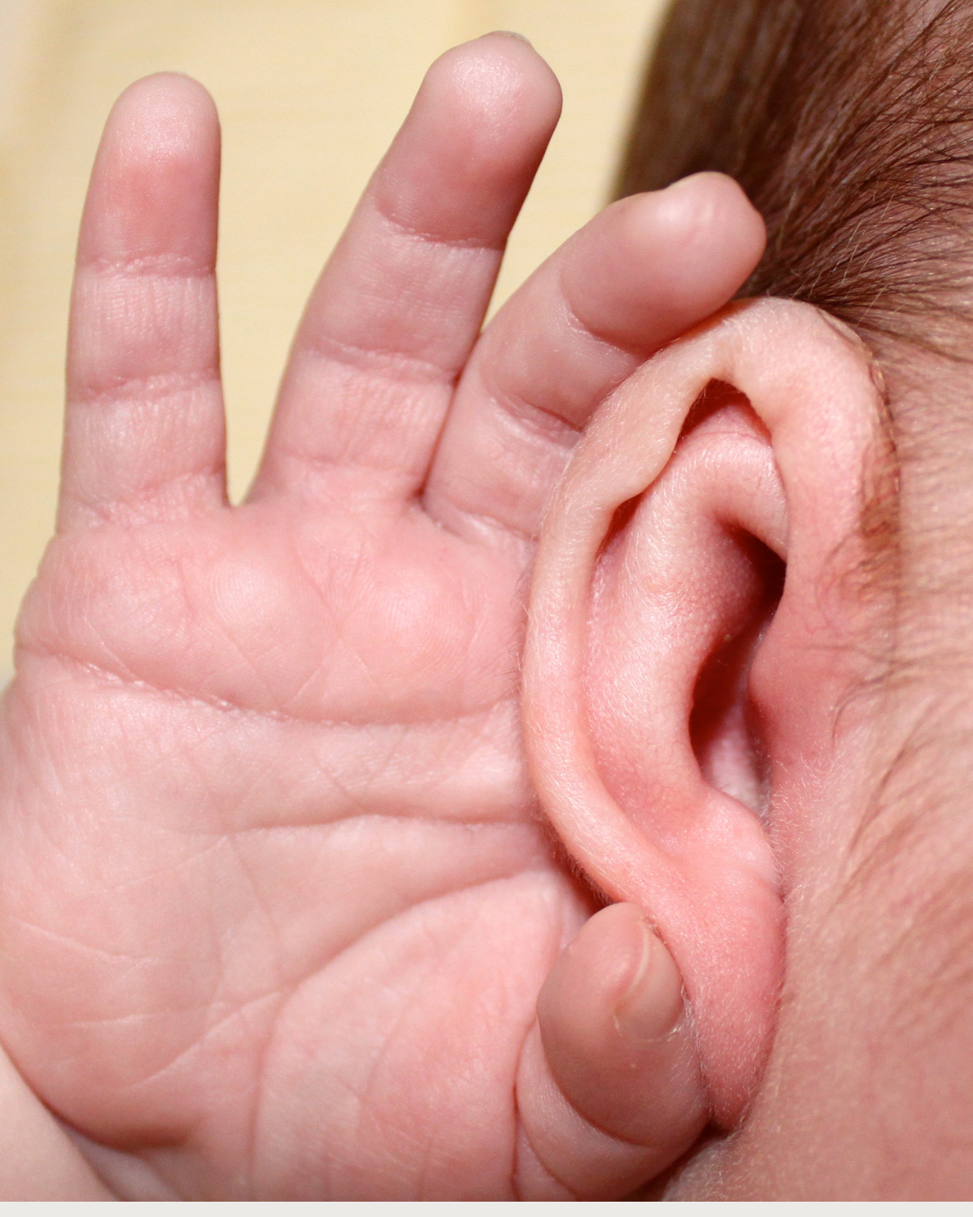 baby holding ear