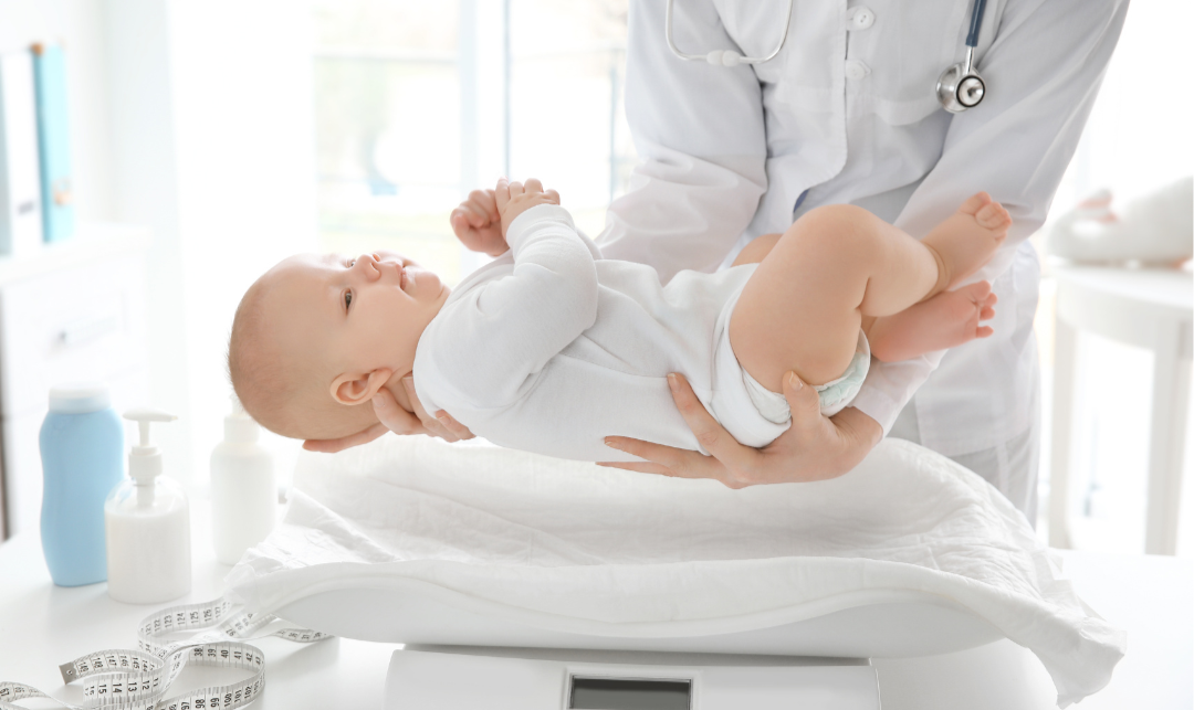 baby about to be put on a weight scale