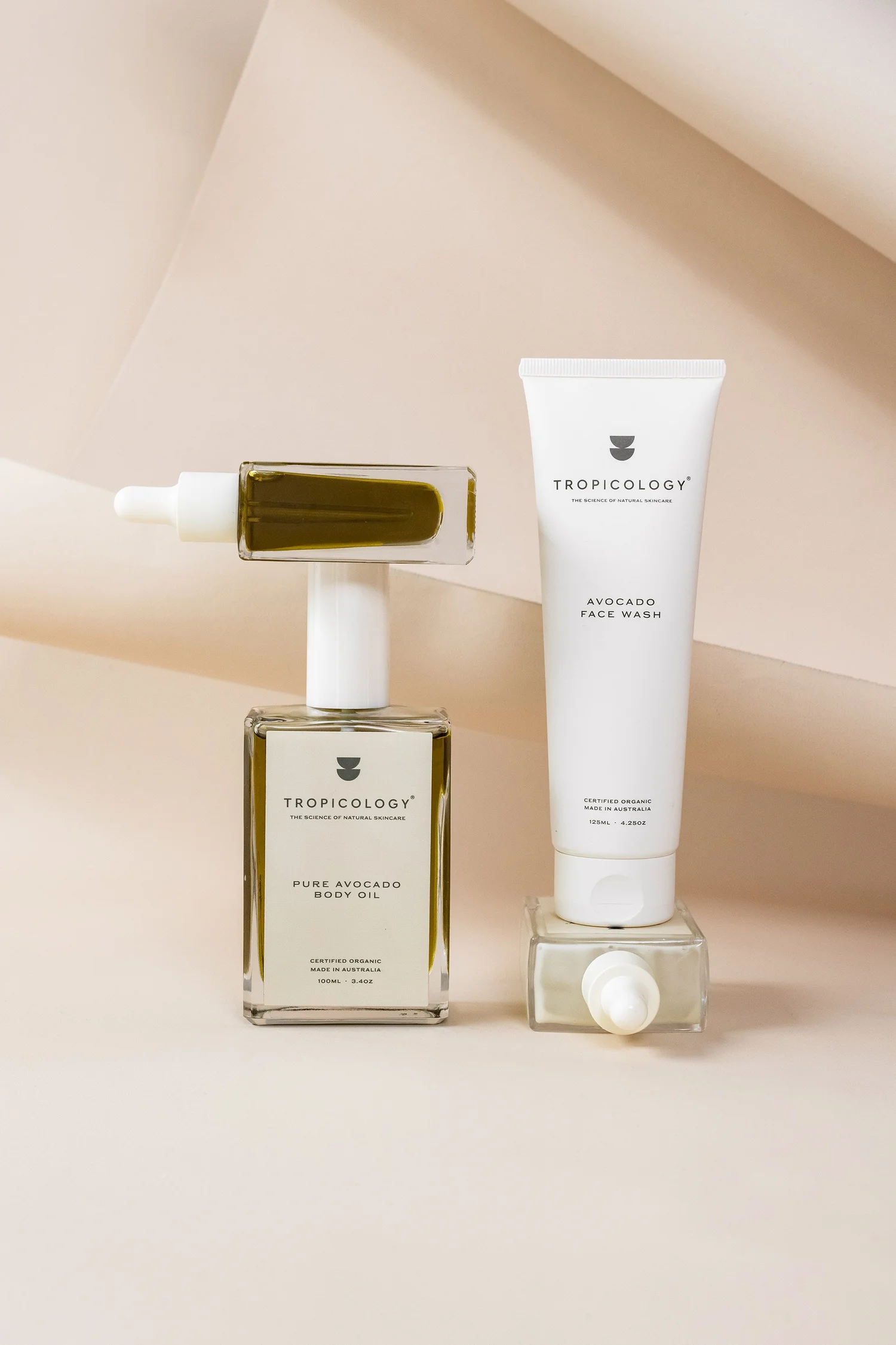 Tropology Pure Avocado Body Oil and Avocado Face Wash displayed on a neutral background.