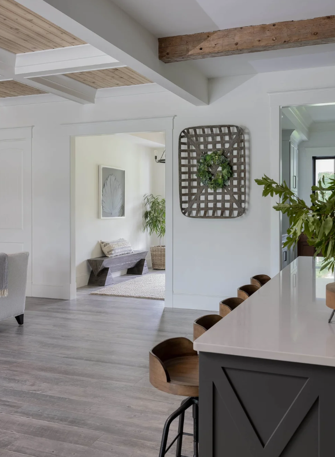 full-service-interior-design-fairhaven-ma-wood-finishes-kitchen-open-concept-isand-with-bar-stools-wood-floor-ceiling-beams-and-wood-ceiling-new-england.png