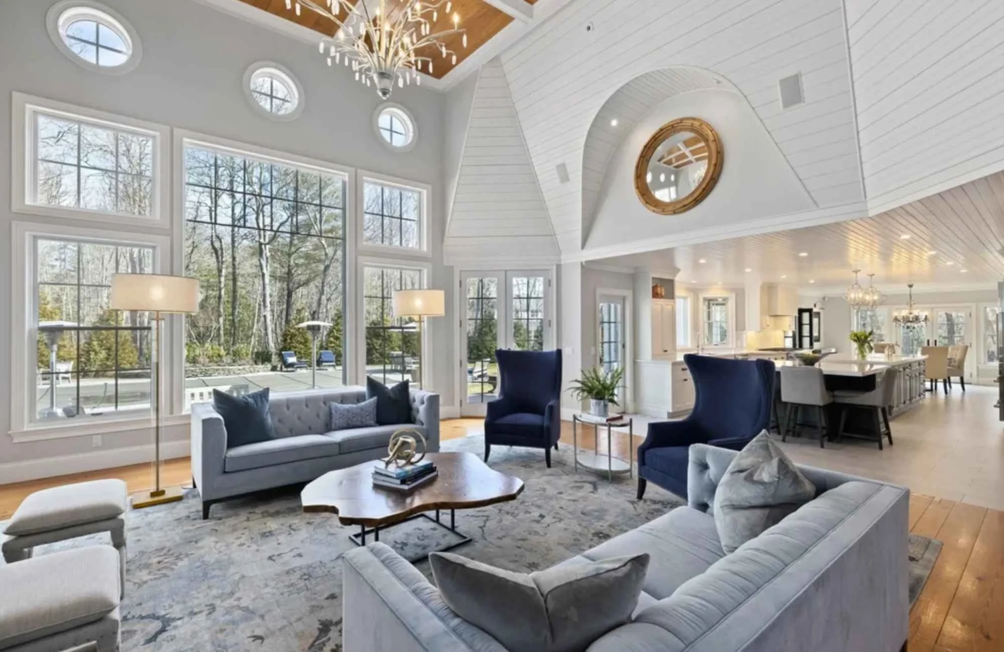 ironwood-studio-new-england-full-gut-renovation-large-coastal-living-room-high-ceilings-large-windows-view-into-kitchen-custom-furnishings.jpg
