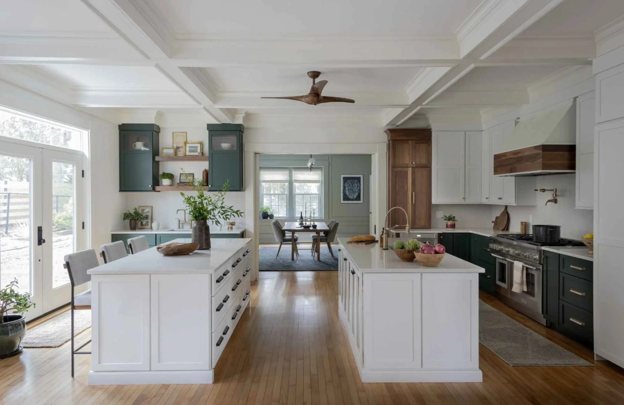 full-service-interior-design-new-england-advantages-of-design-build-firm-large-kitchen-two-islands-deep-green-cabinets-view-into-dining-room-timeless.jpg