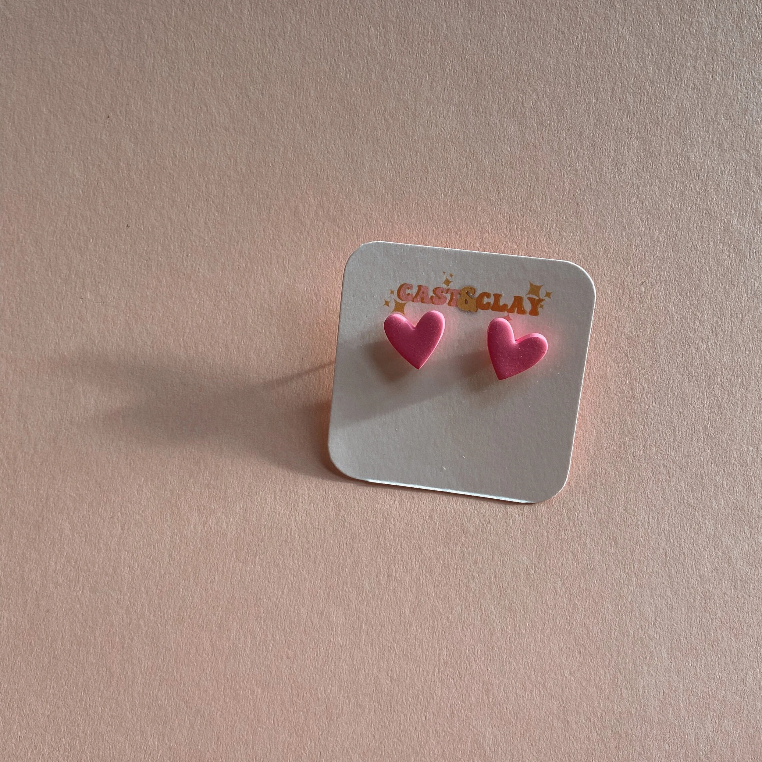 Pink heart studs.png