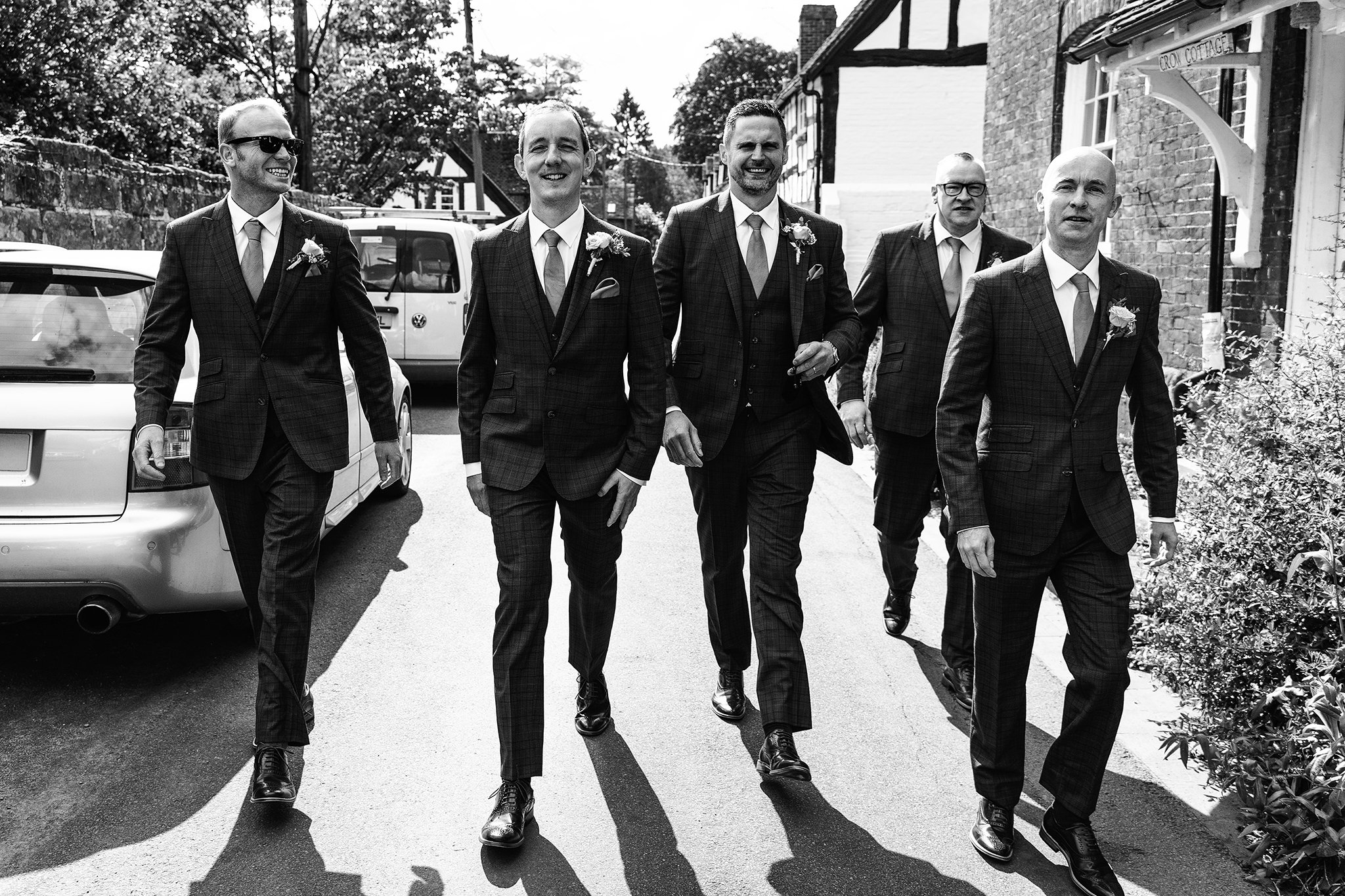  A groom and his groomsmen walk to the church ahead of the wedding 
