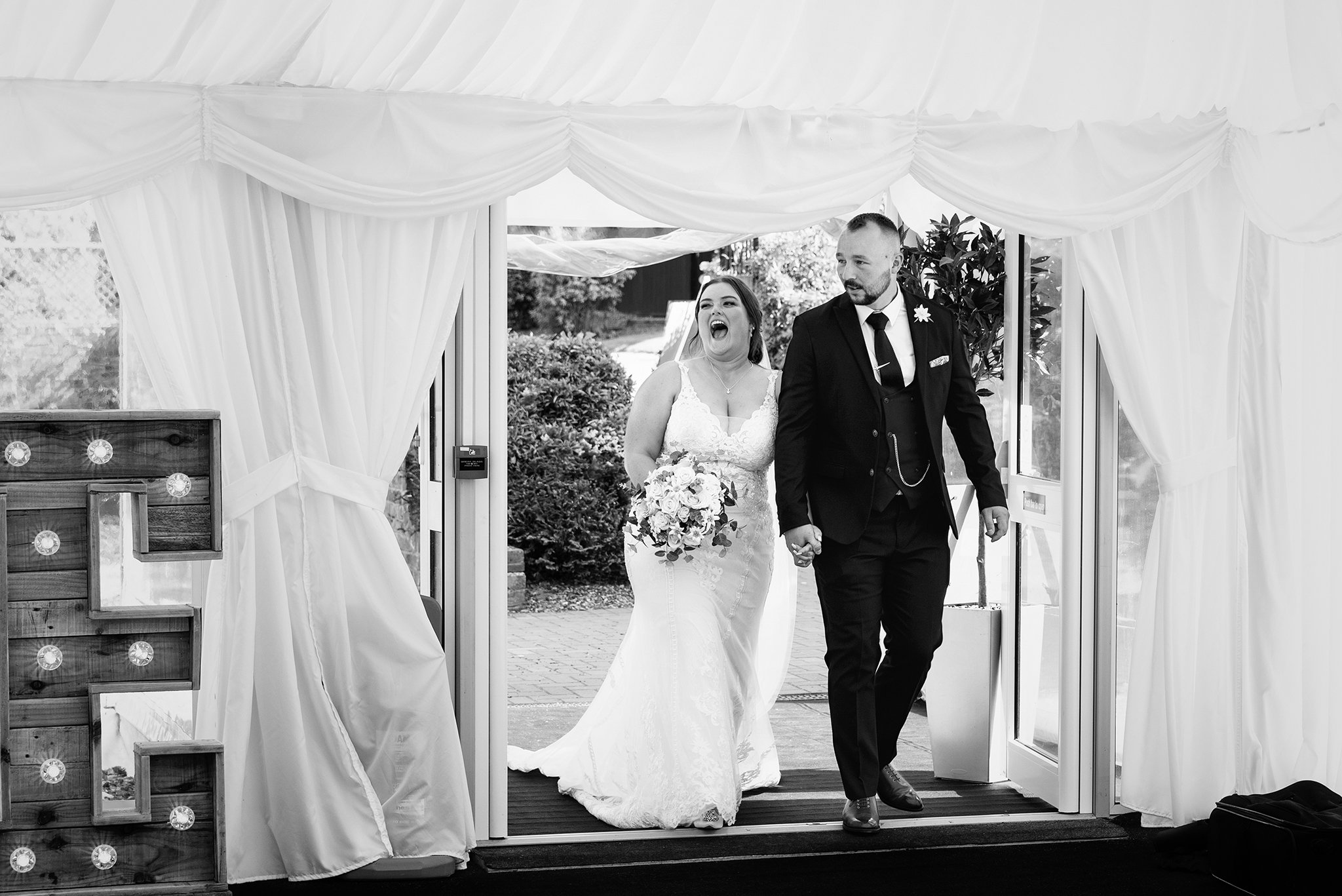  A bride and groom entering their wedding reception at the Shropshire golf club in Muxton 