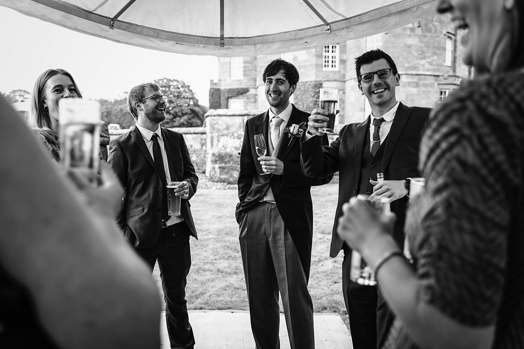  A groom and his friends at a wedding reception 