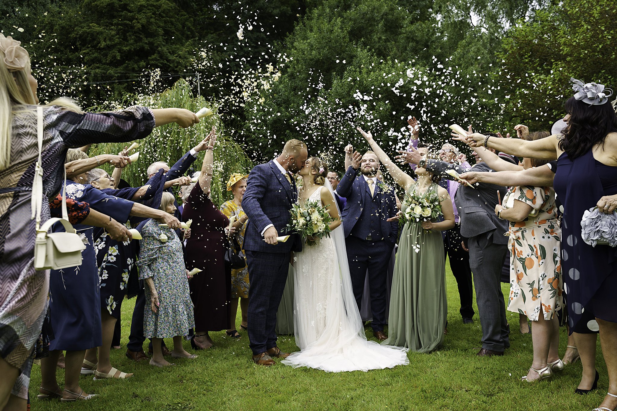  Confetti is thrown over a bride and groom at a wedding reception 