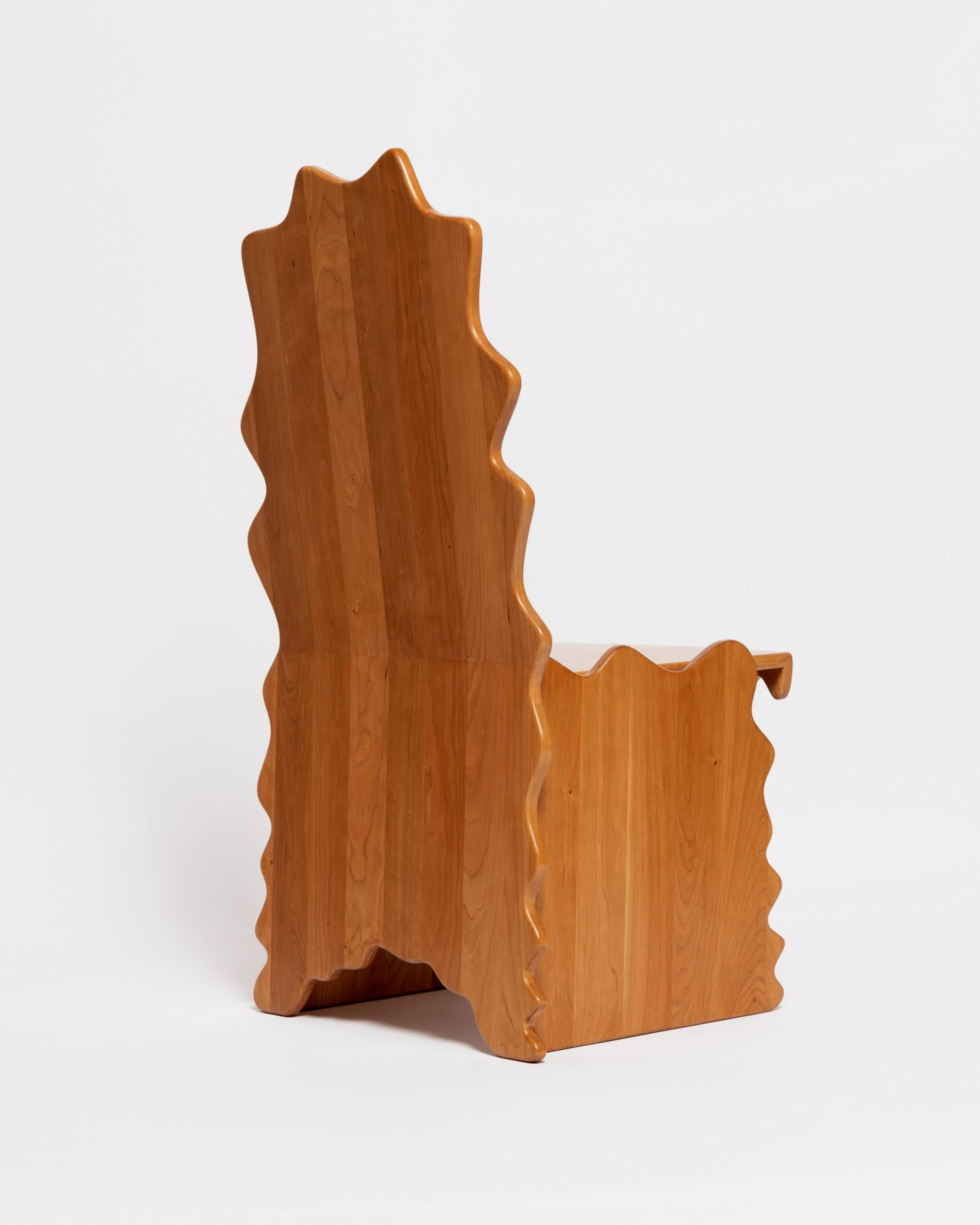 A wooden sculpture shaped like a map of the state of Utah, with a smooth, polished surface and a natural wood grain finish.