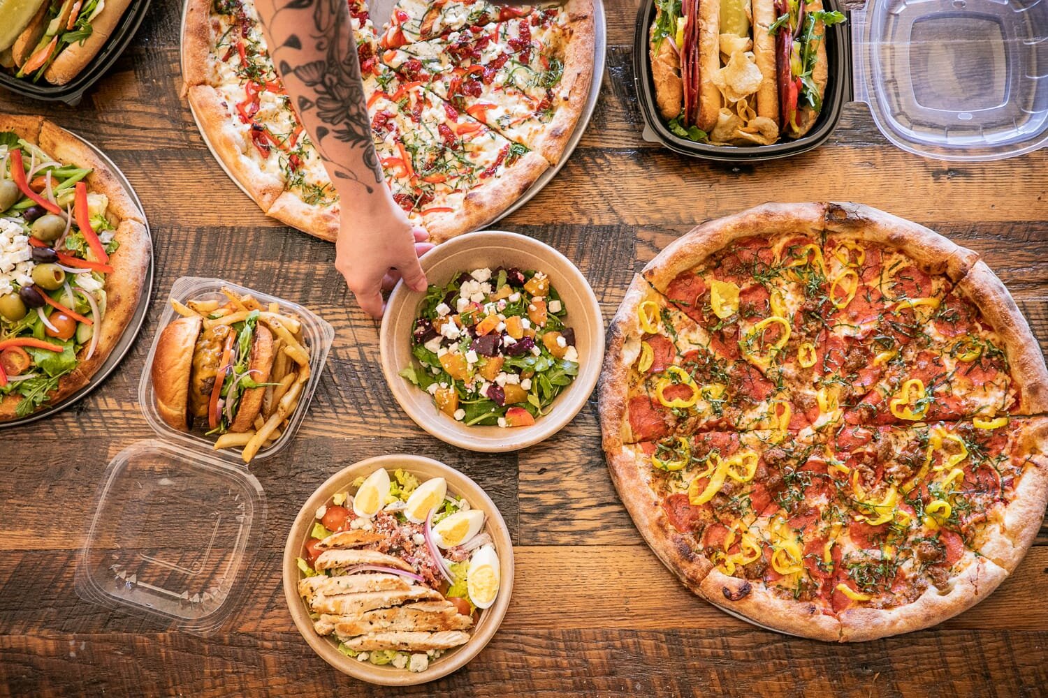 spread of pizza, salads, and burgers