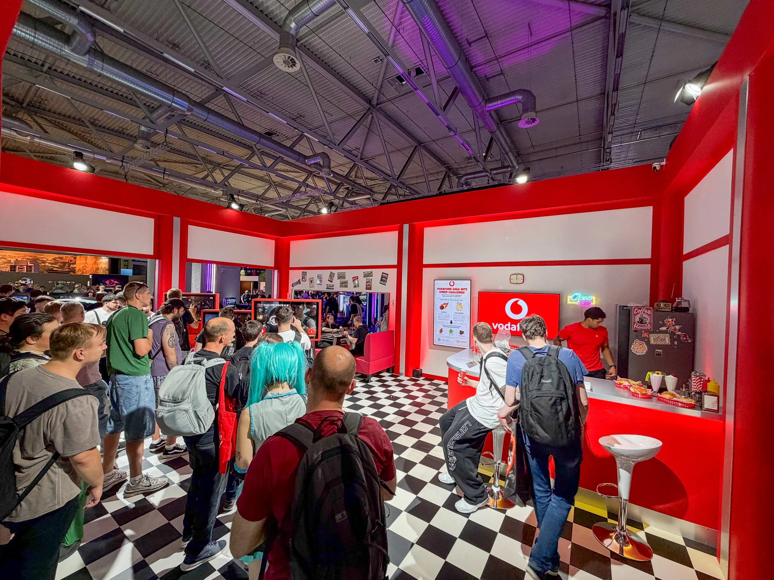 Vodafone Giga Bite Diner activation at Gamescom 2026, with visitors inside the American diner inspired gaming space