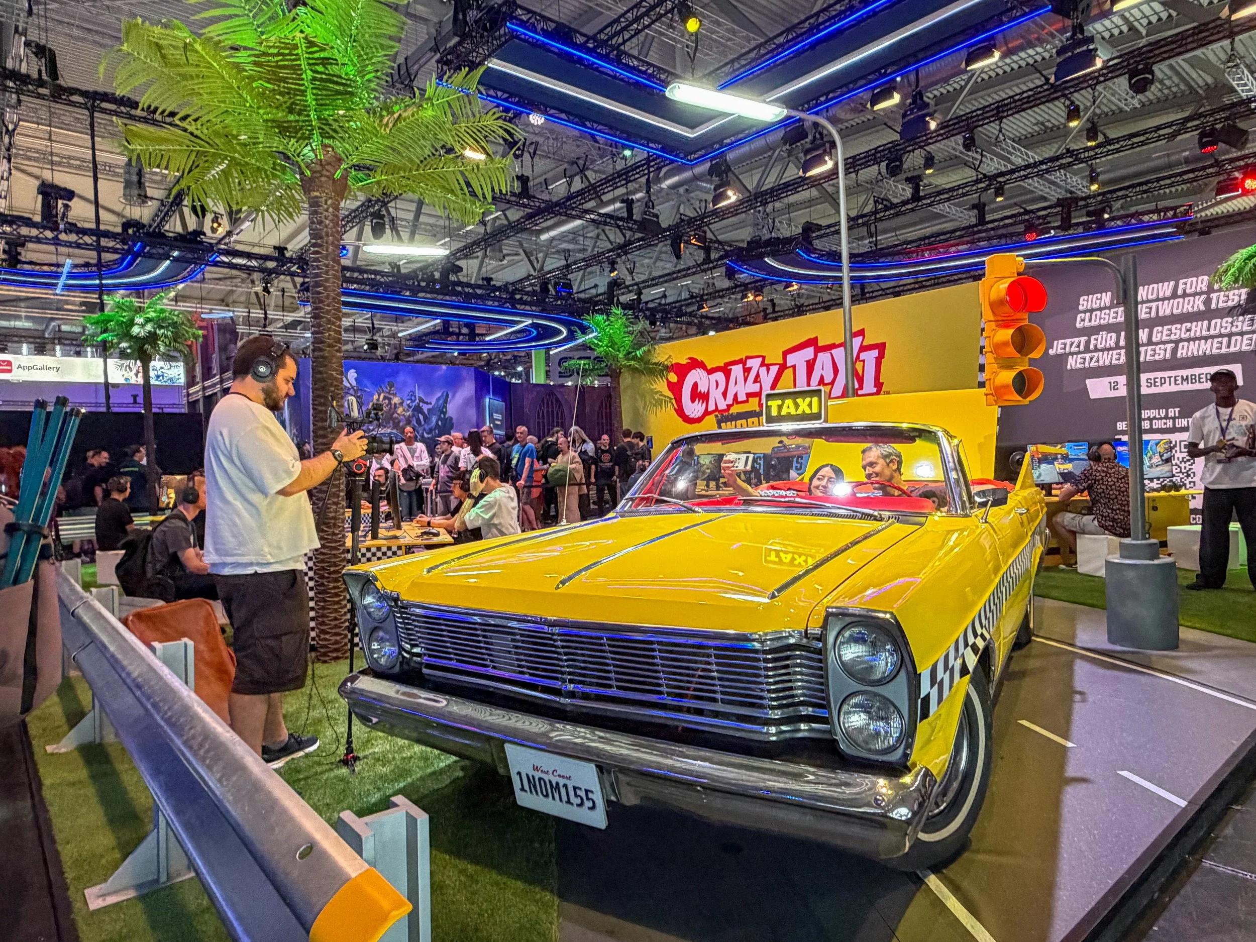 SEGA Crazy Taxi experience at Gamescom 2026 featuring a full size yellow taxi and visitors exploring the interactive display