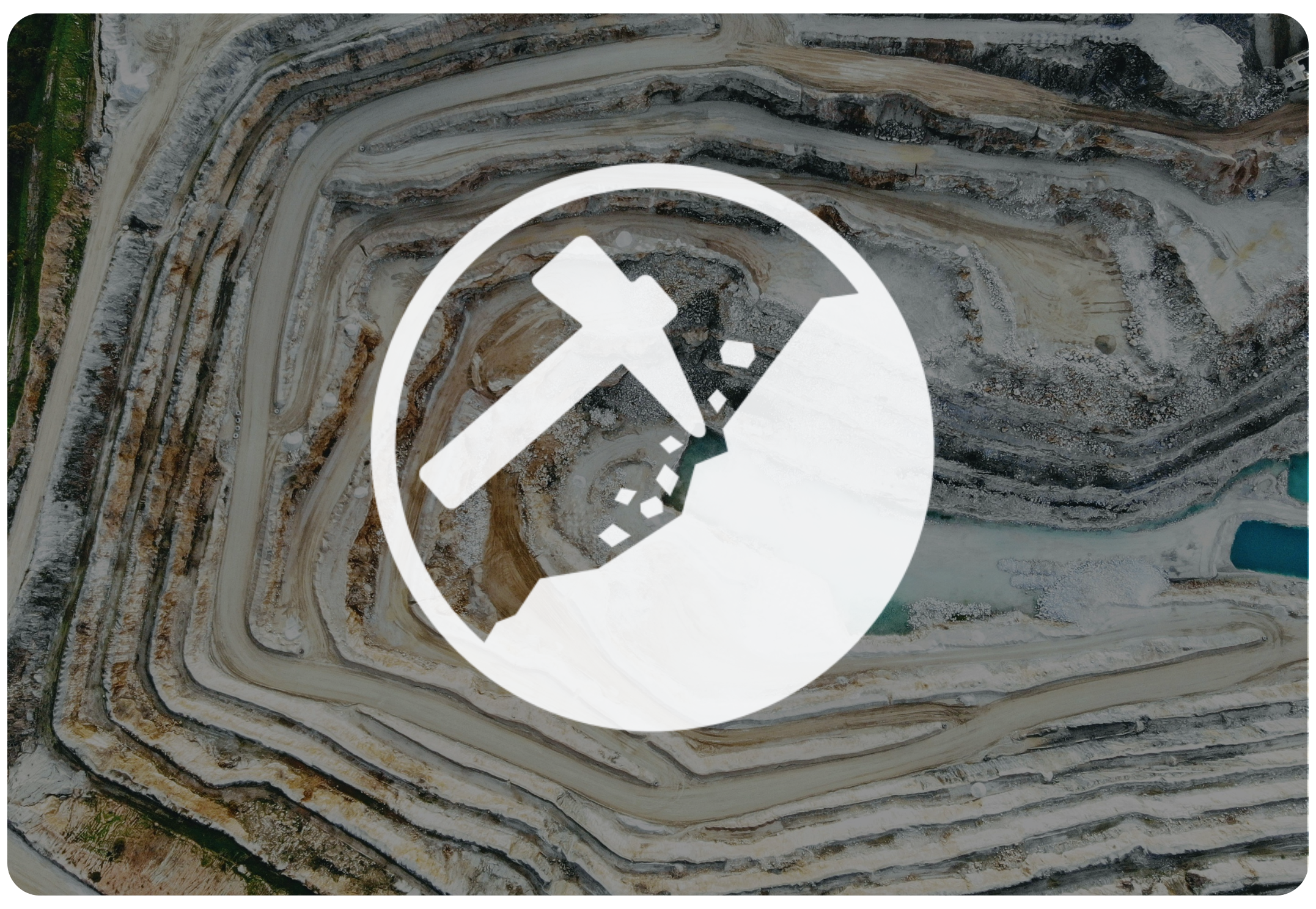 Open-pit mining quarry with terraced layers of earth and rocks, clear blue sky above.