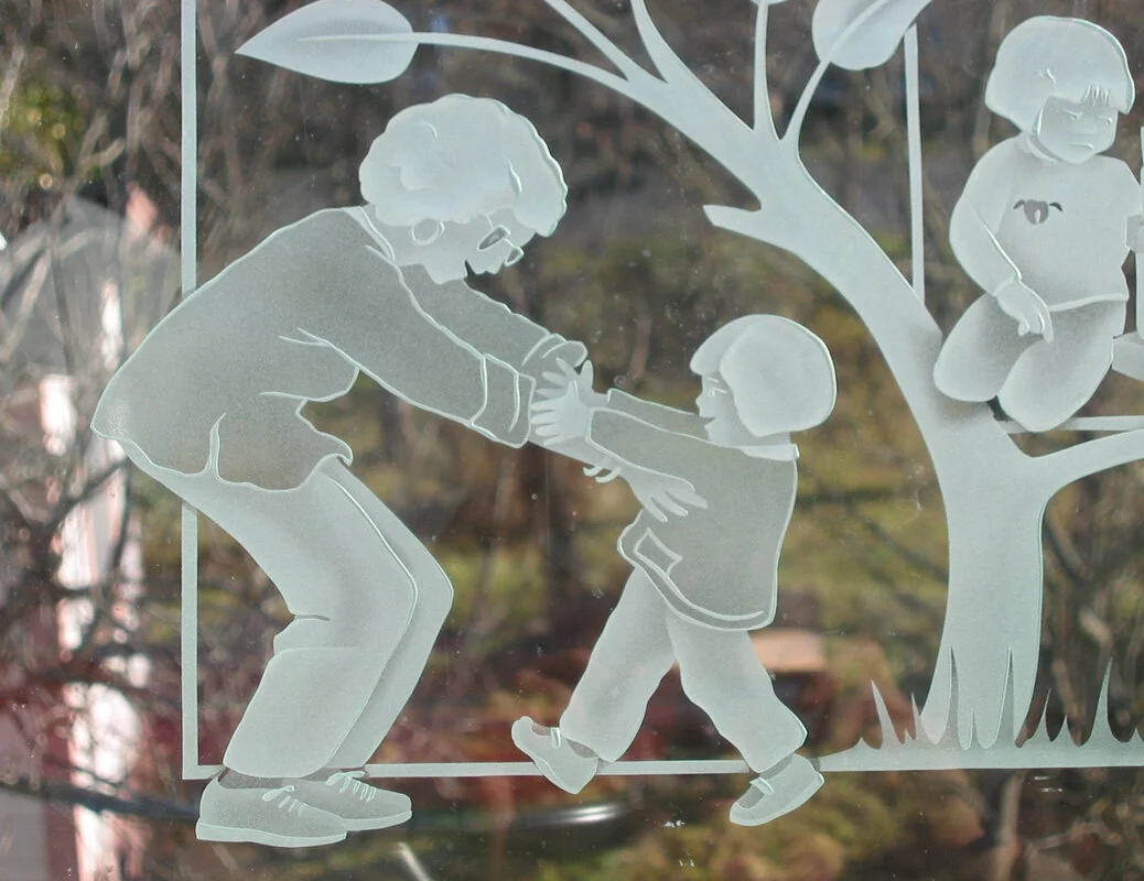 etched-glass-detail-with-teacher-greeting-child.jpg