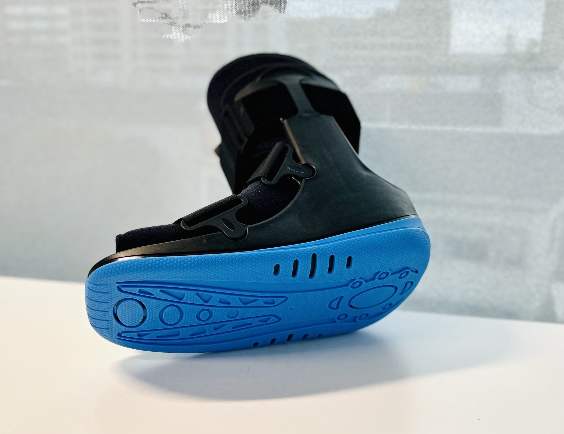 Black cam boot with blue under sole available in store