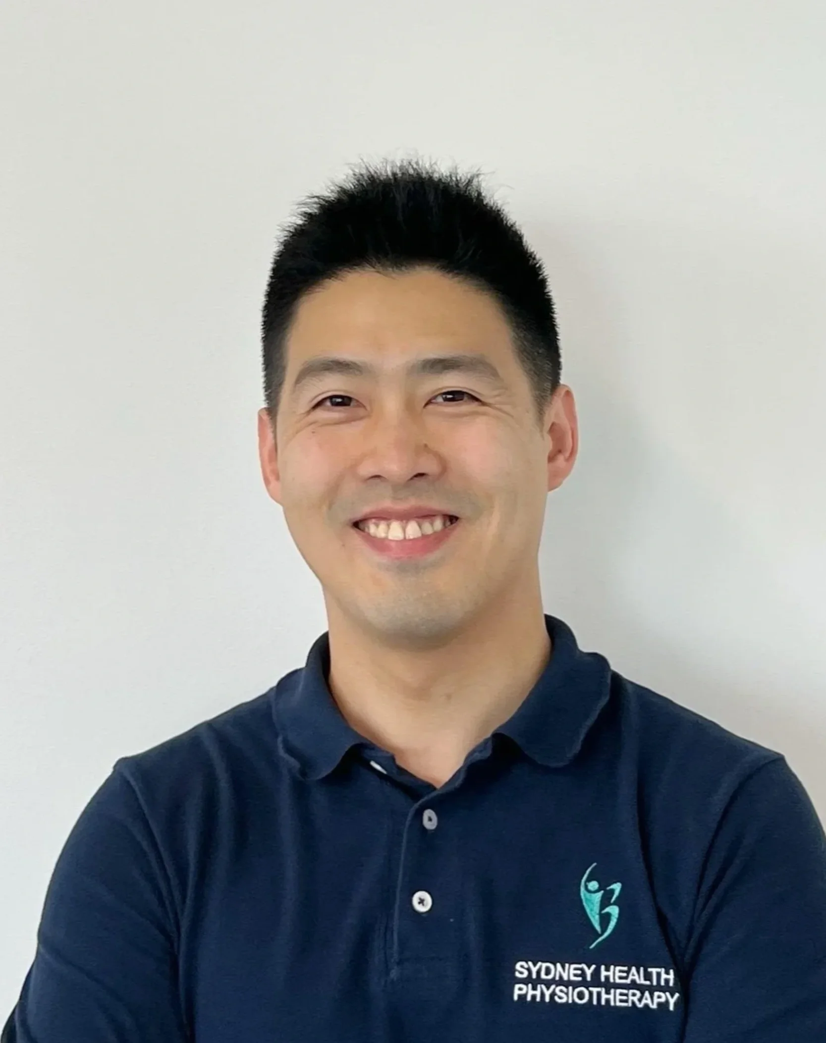 Man with black short hair smiling