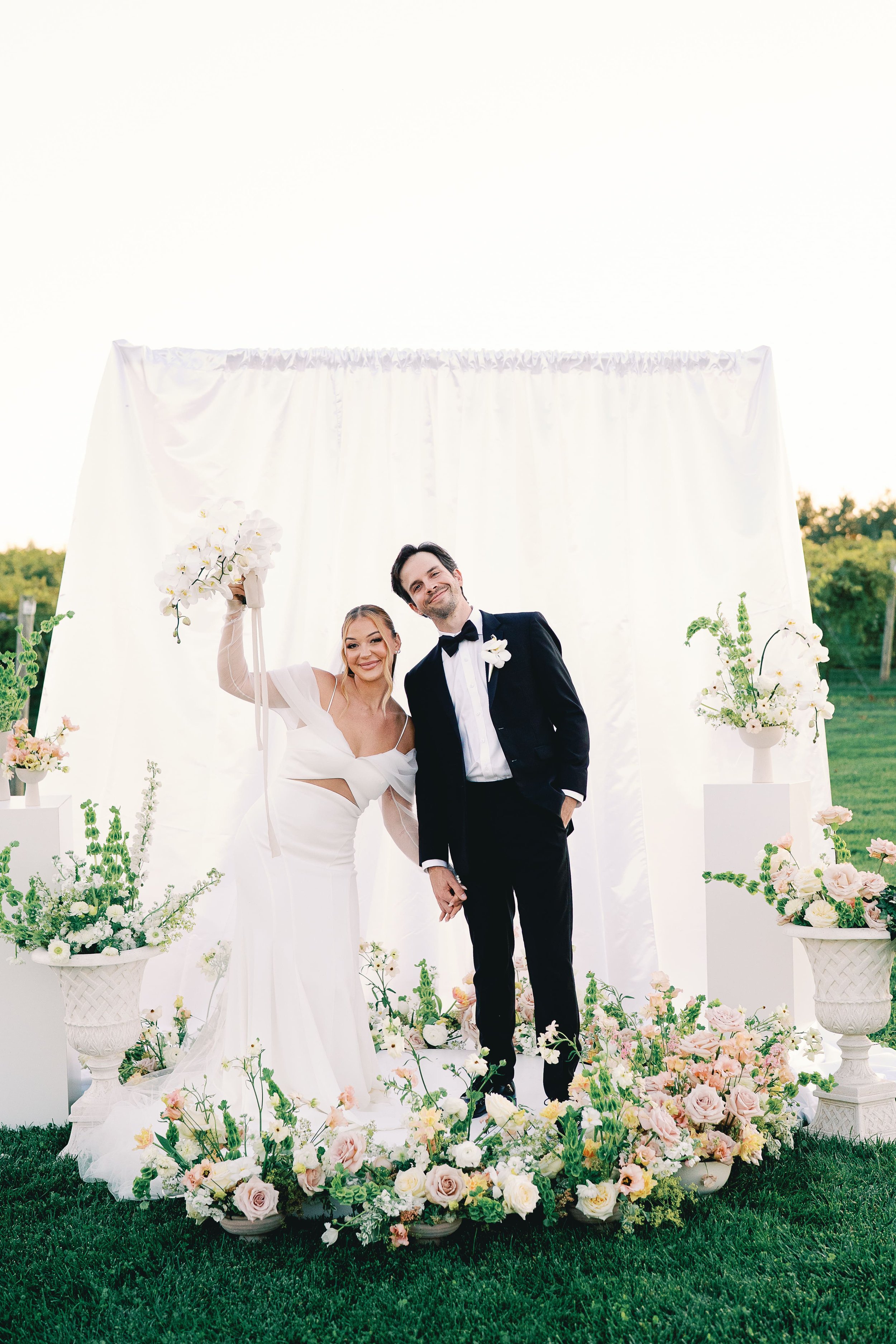 Newlyweds say I Do at their outdoor winery wedding ceremony. Florals by June and Jane Flower Co. Photographed by Rachel Elle Photography
