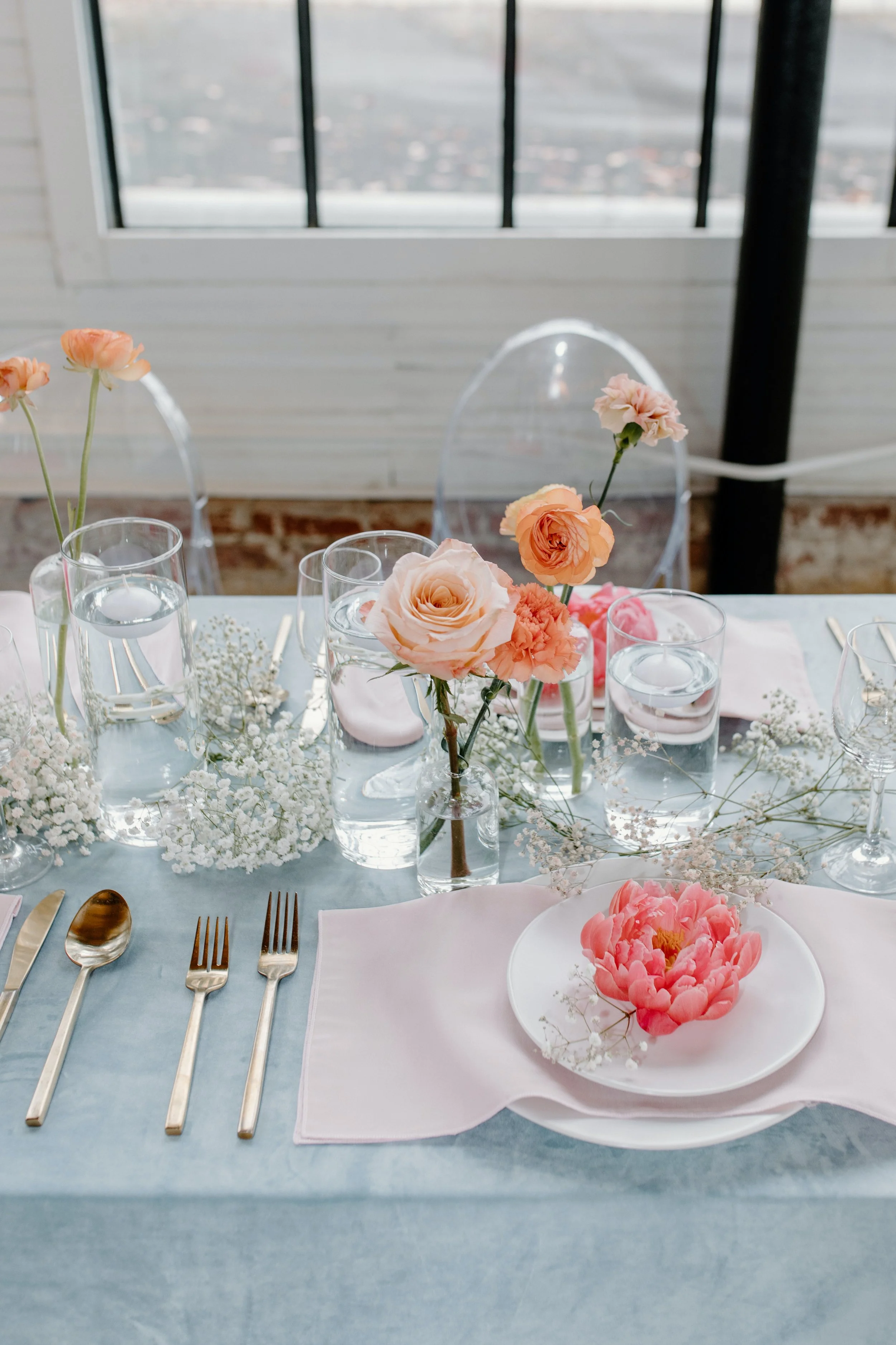 A stunning bridal shower tablescape with bright florals and blue velvet linen.
