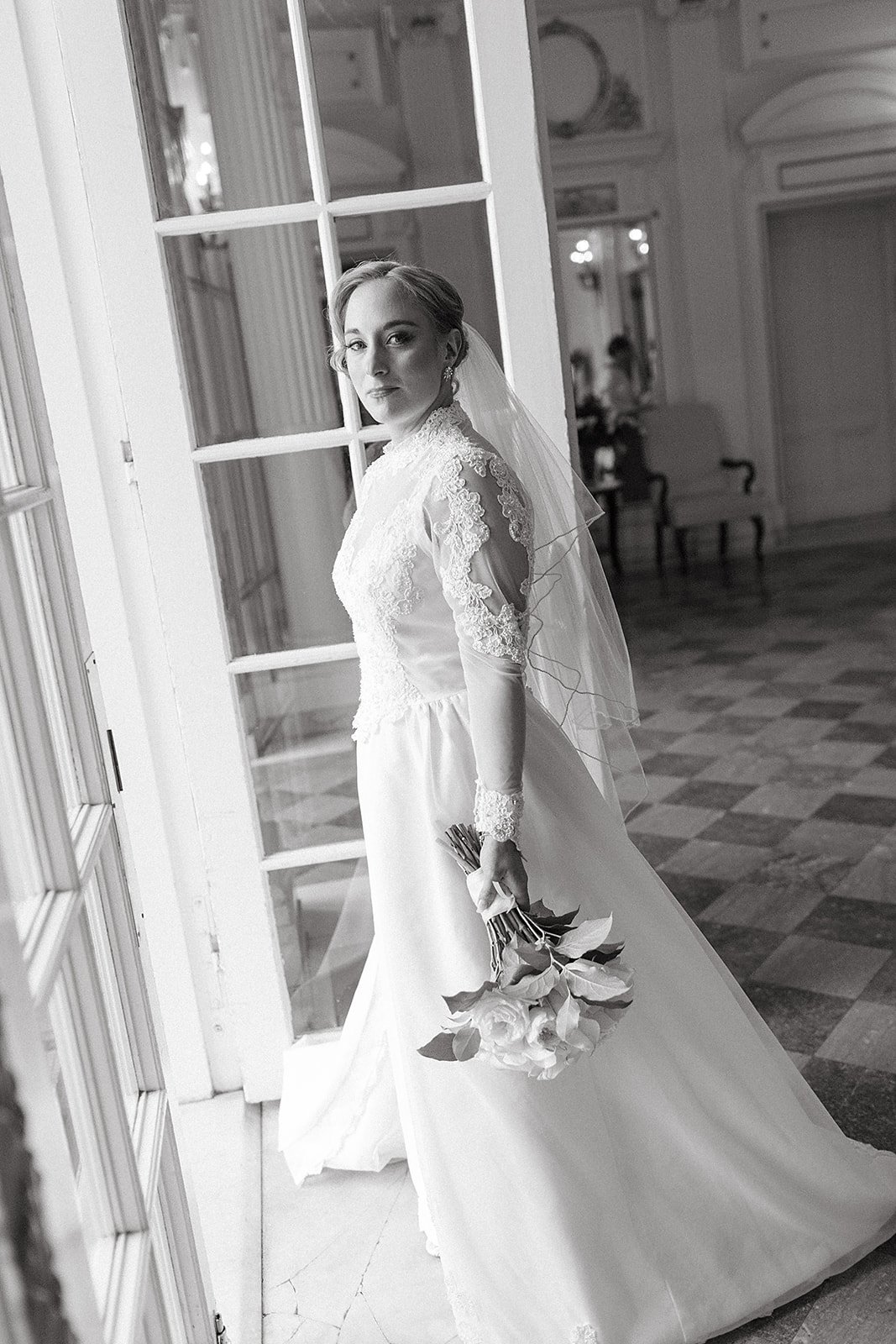 Bridal portraits, with the bride in a lace long sleeve gown with chiffon skirt, and classic hair and makeup