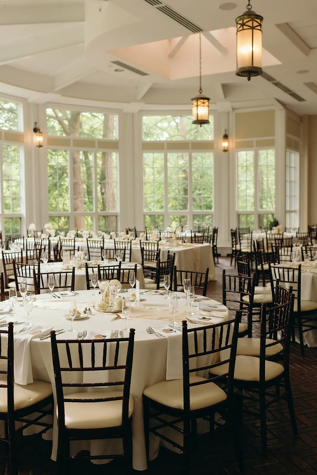 A vintage art deco inspired wedding reception at Tupper Manor, with gold feather table runners, pearls, white roses, crystals and candles