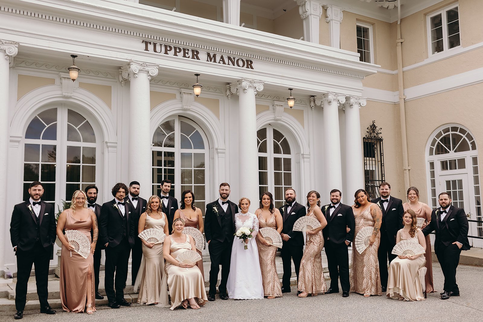 Wedding party portraits at Tupper Manor, with the bridesmaids in champagne and blush gowns, the groomsmen in black suits