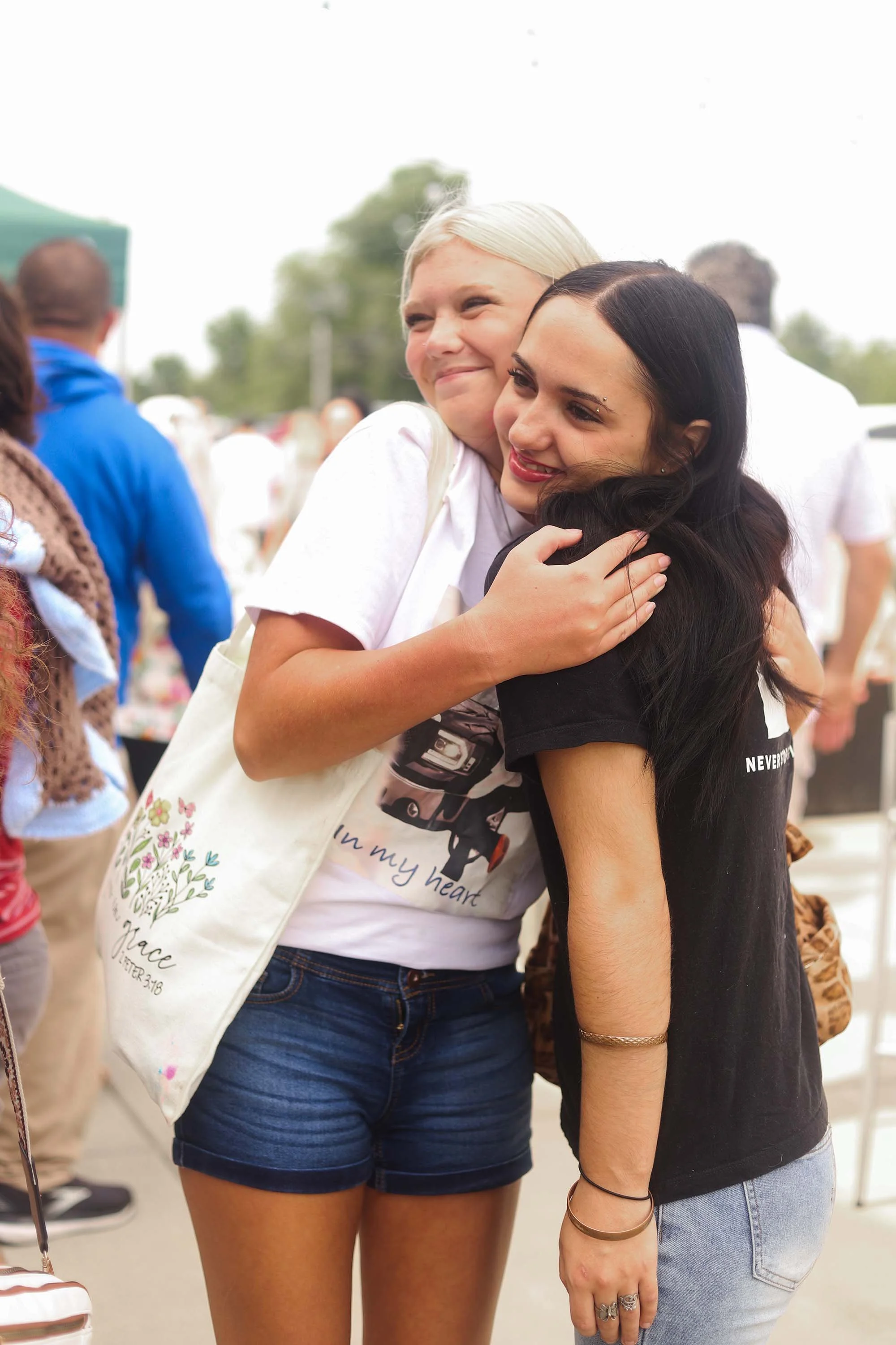 Volunteer embracing a child at Grace Kids ministry