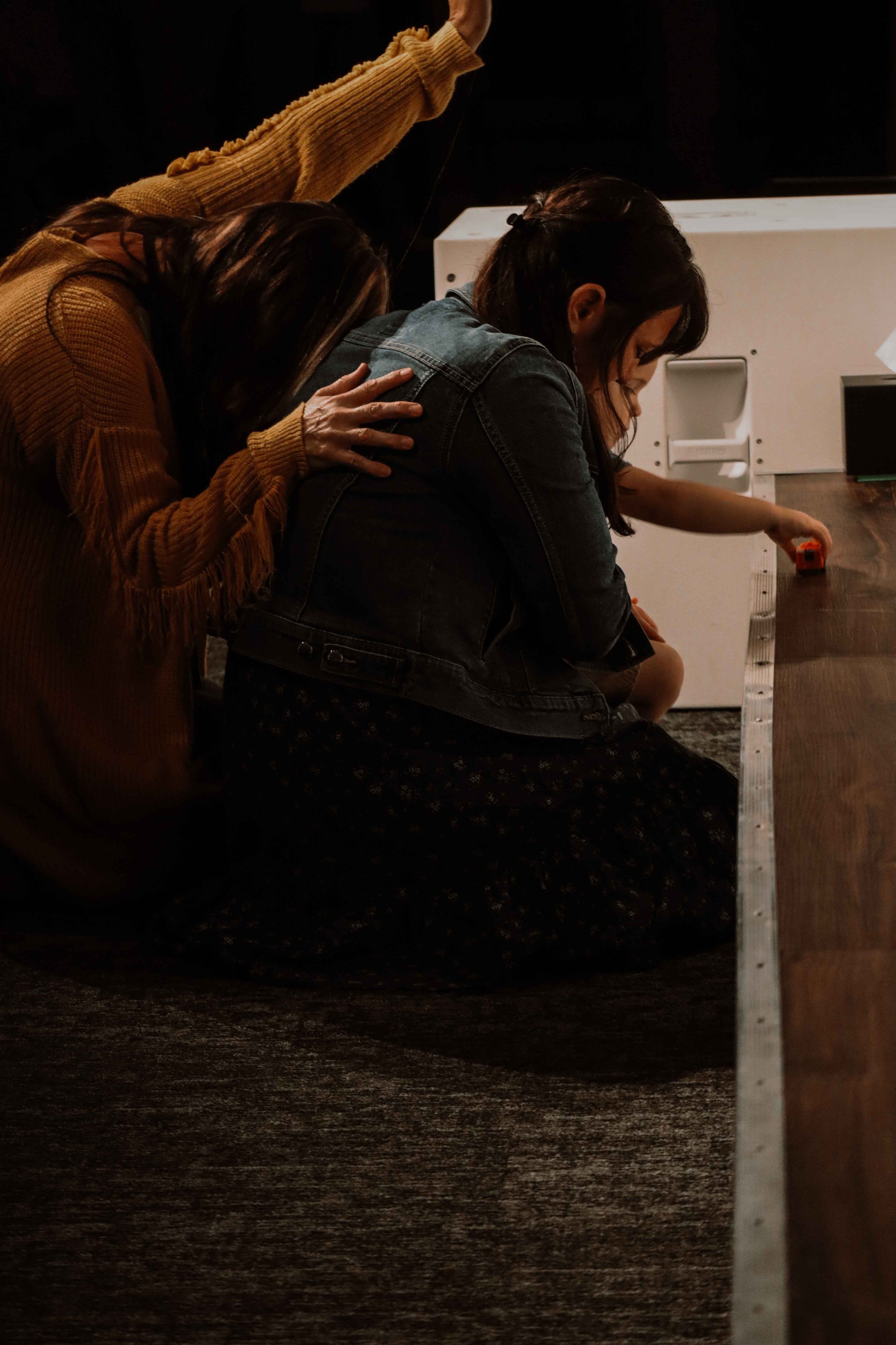 Worshipper kneeling in prayer at Field of Grace