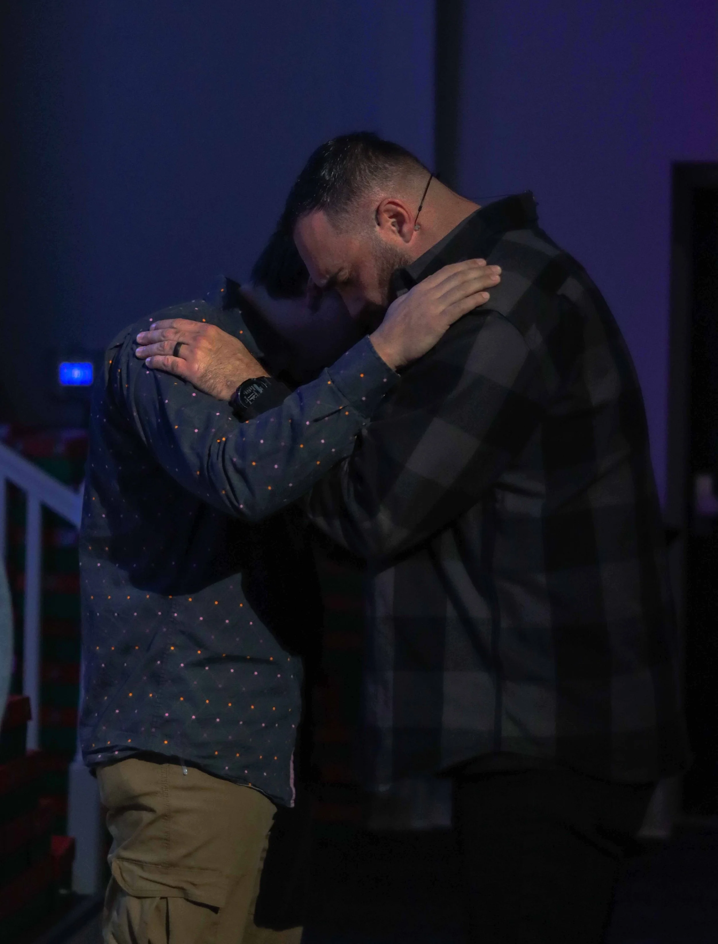 Two people sharing an embrace during a Field of Grace service