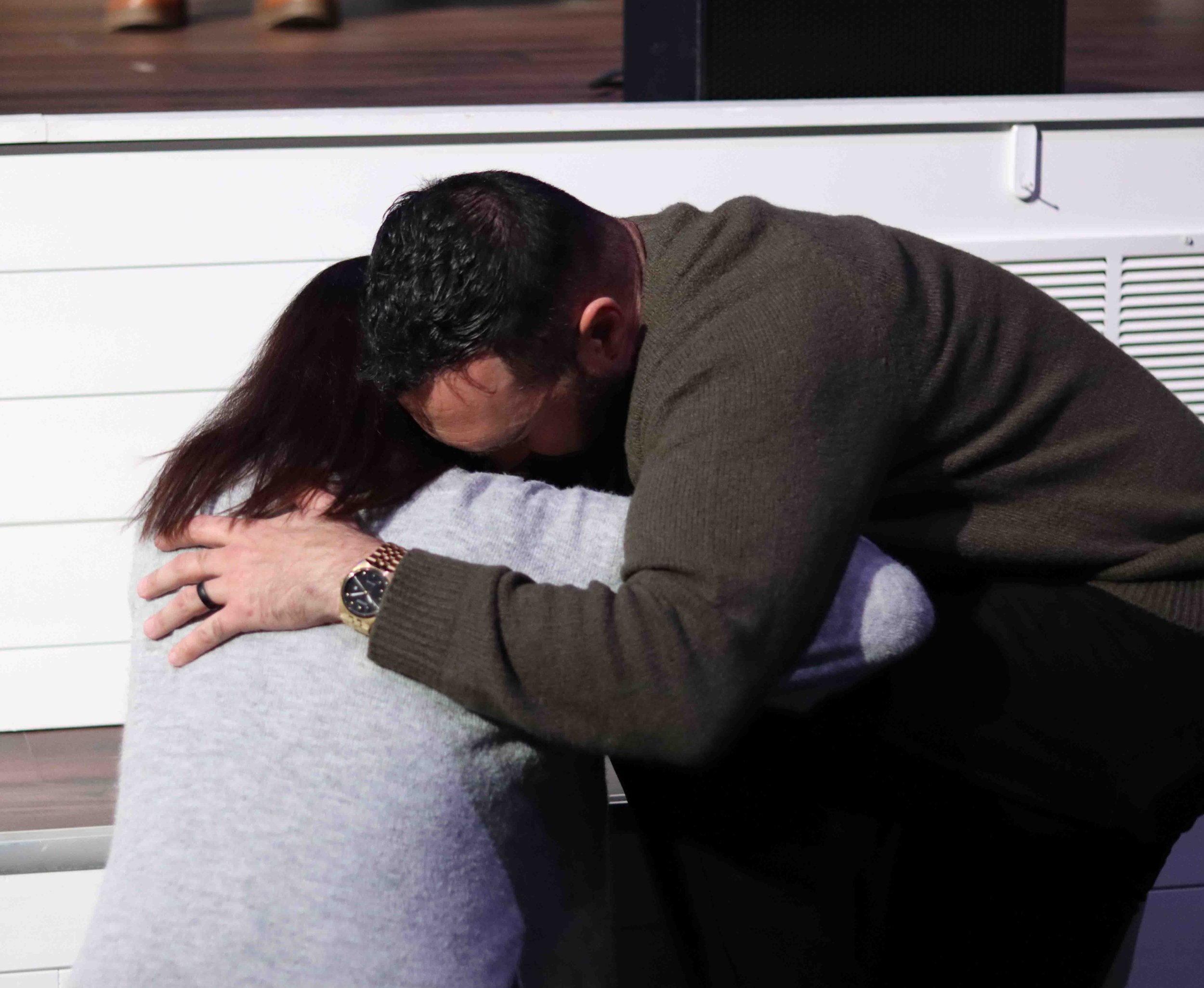 Congregation member bowed in prayer during a Field of Grace service