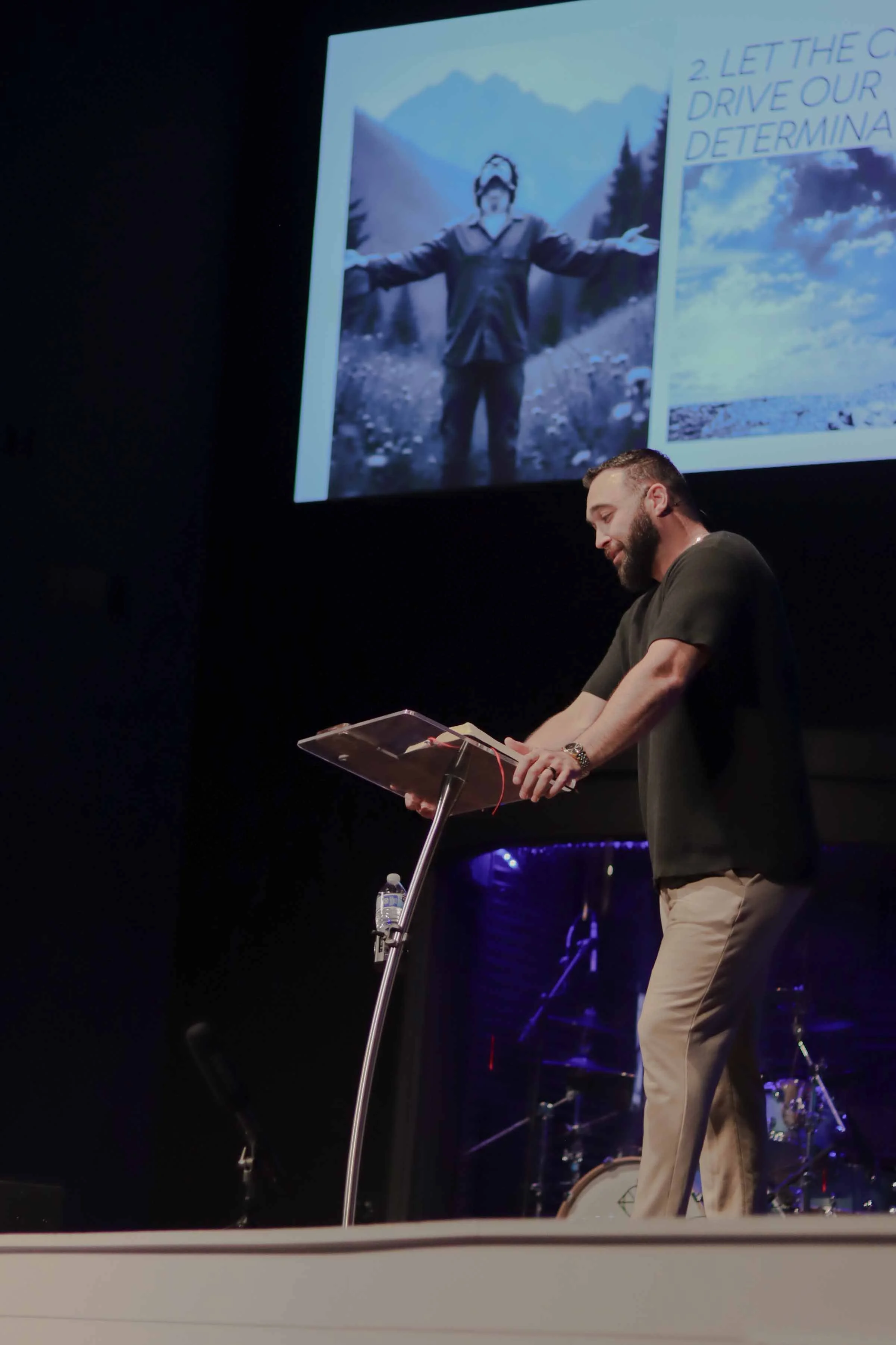 Speaker leading worship on stage at Field of Grace Baptist Church in Bullitt County, Kentucky