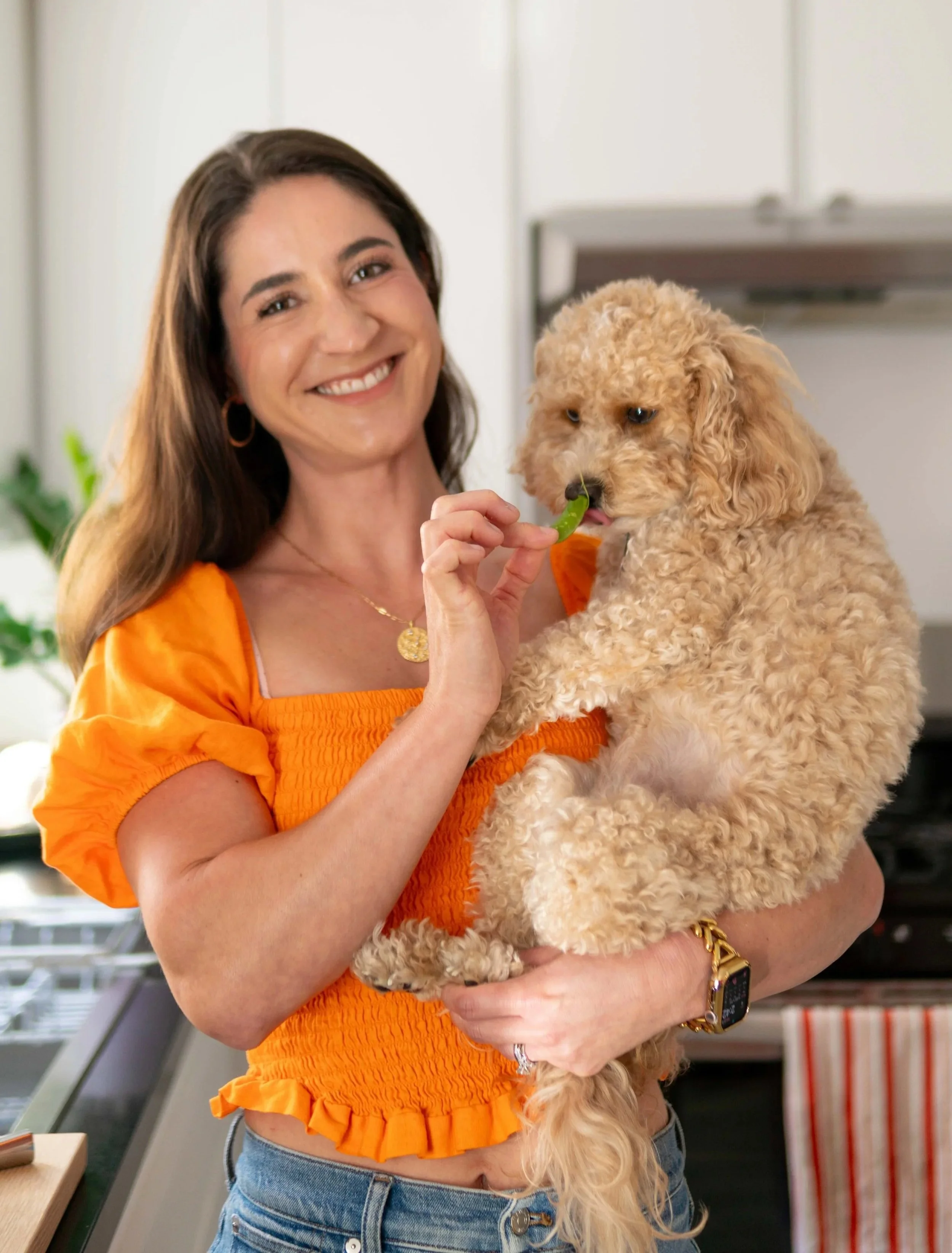 Jillian Beck-Rogers fertility nutrition coach holding cavapoo dog