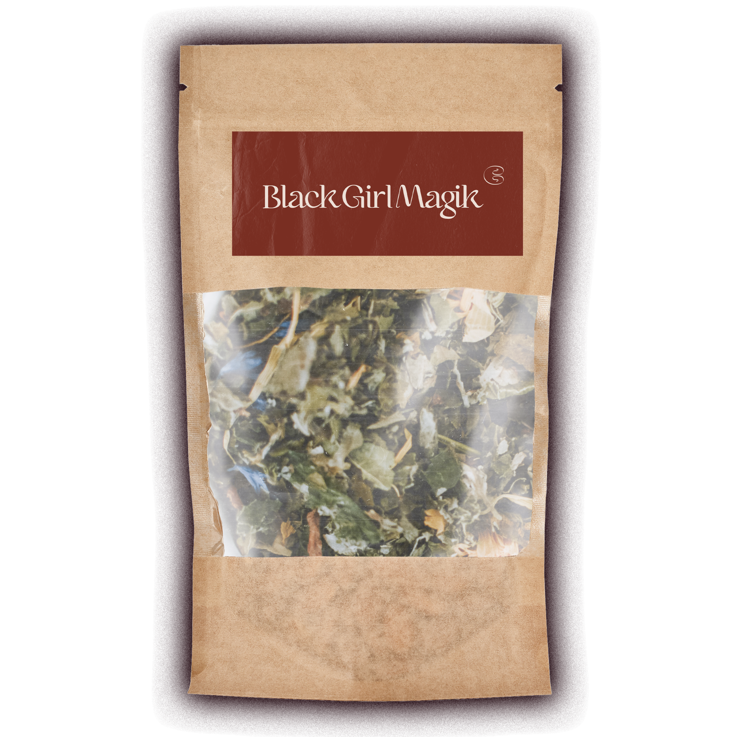 A blue glass bottle with a white cap labeled 'Black Girl Magik' next to a paper package of dried herbs labeled 'Black Girl Magik.'