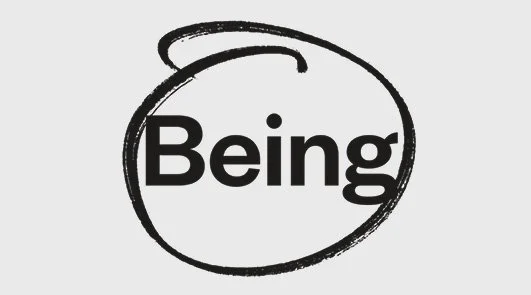 A black and white logo with the word 'Being' inside a roughly drawn oval.