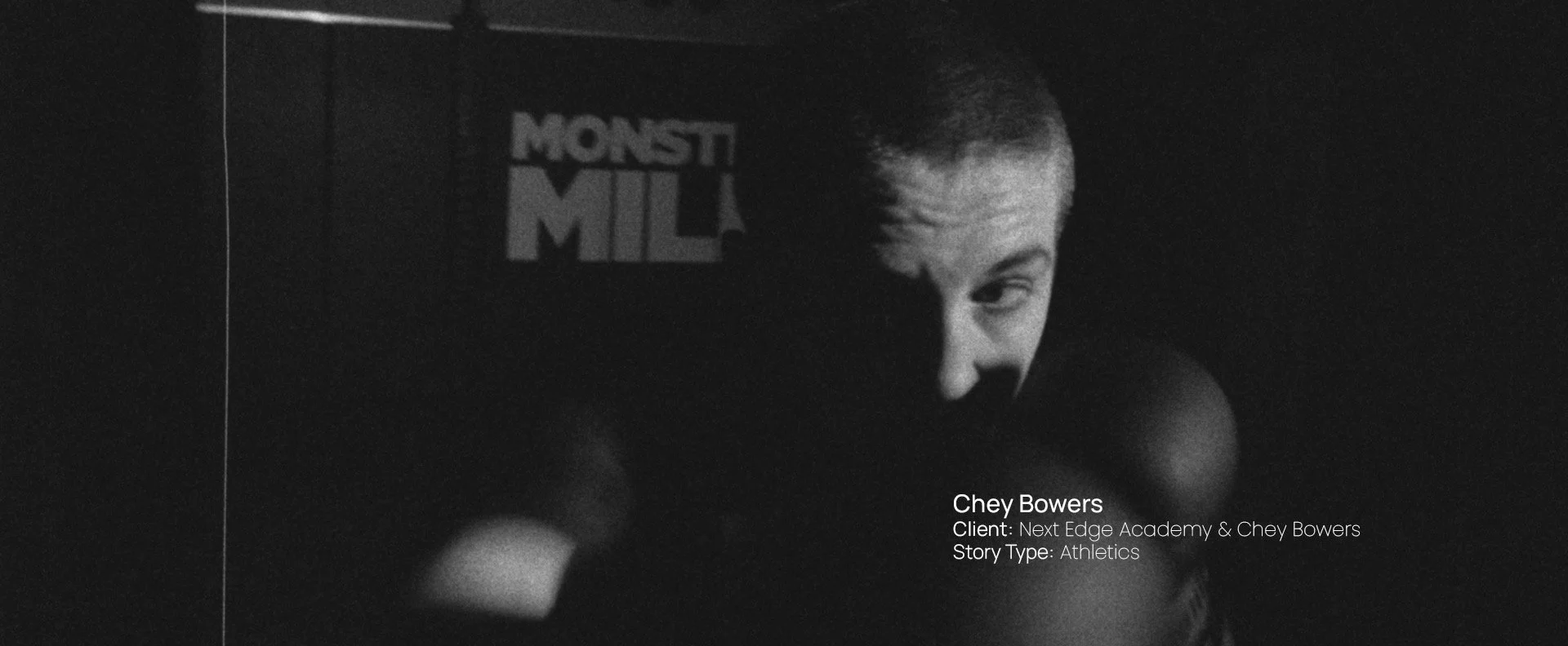 Black and white portrait of boxer Chey Bowers in a gym, still from a Passenger Productions athletics documentary for Next Edge Academy