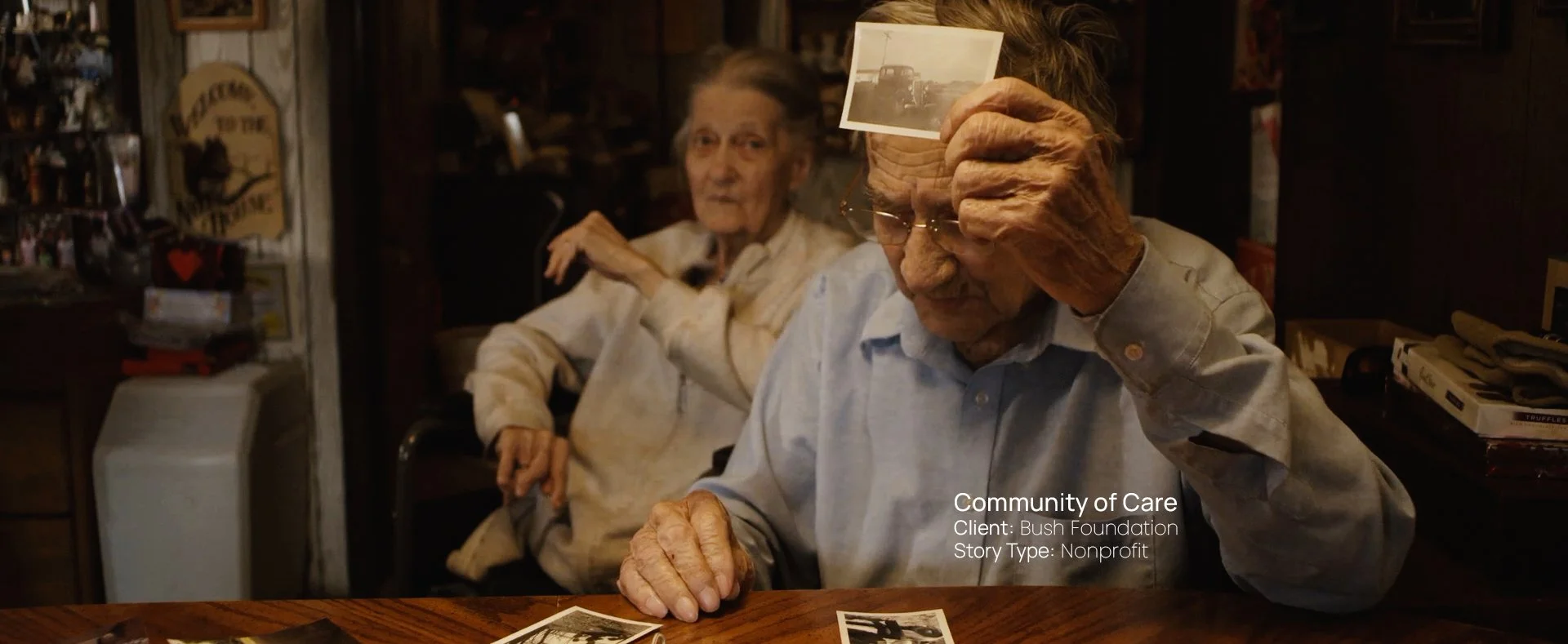 Elderly man and woman looking at an old photograph together, still from a Passenger Productions nonprofit documentary for the Bush Foundation