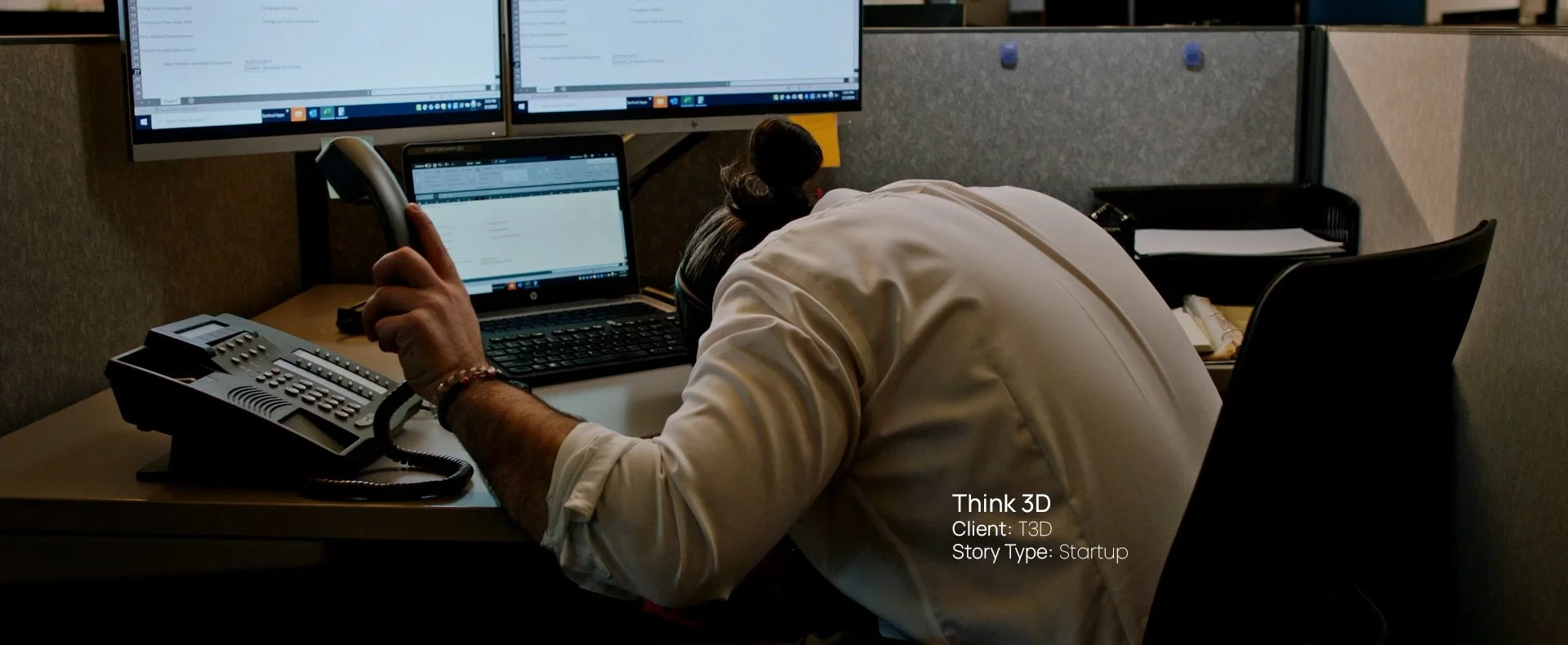 Man working at a multi-monitor desk setup, still from a Passenger Productions startup documentary for Think 3D