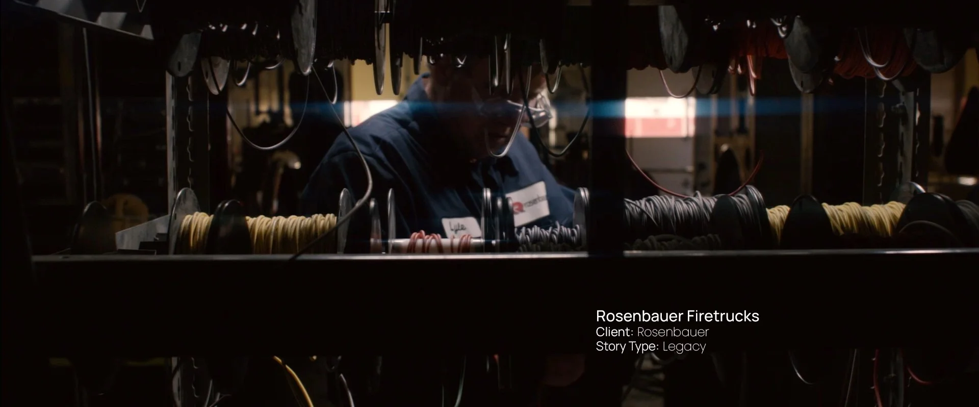 Worker assembling wiring on a fire truck production line, still from a Passenger Productions legacy documentary for Rosenbauer