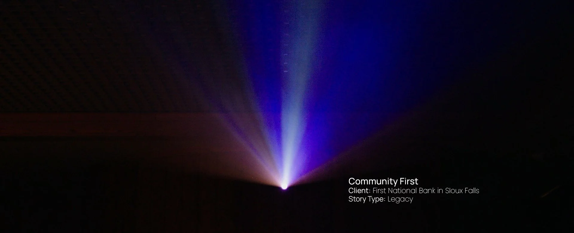 Beam of purple light radiating upward into darkness, still from a Passenger Productions legacy documentary for First National Bank in Sioux Falls