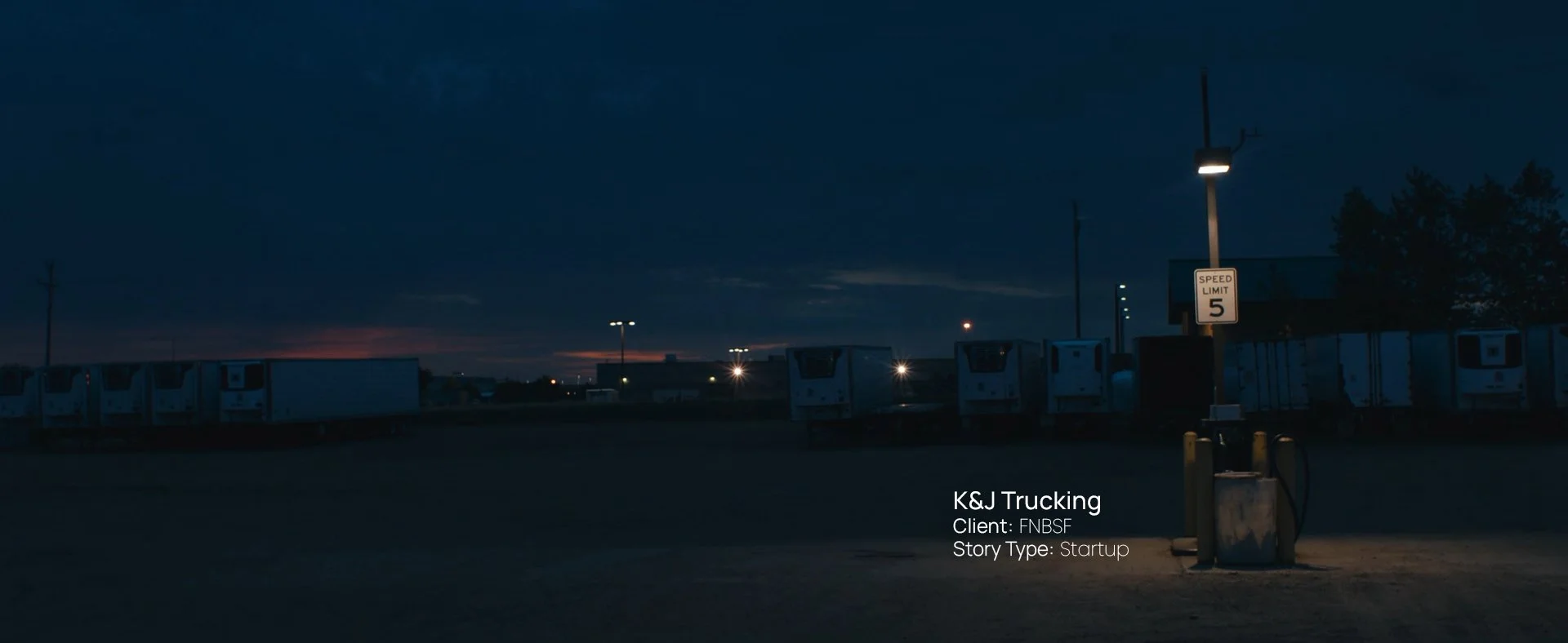 Dusk skyline over a rural parking lot, still from a Passenger Productions startup documentary for K&J Trucking and First National Bank in Sioux Falls