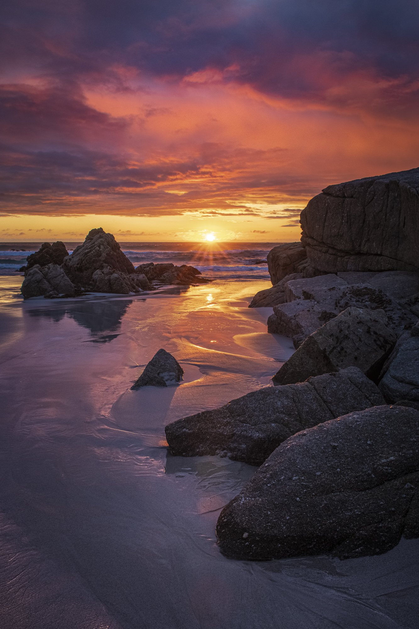 Vibrant sunset over Pebble Beach with glowing shoreline, fine art photo print by Jason Bradley Gallery