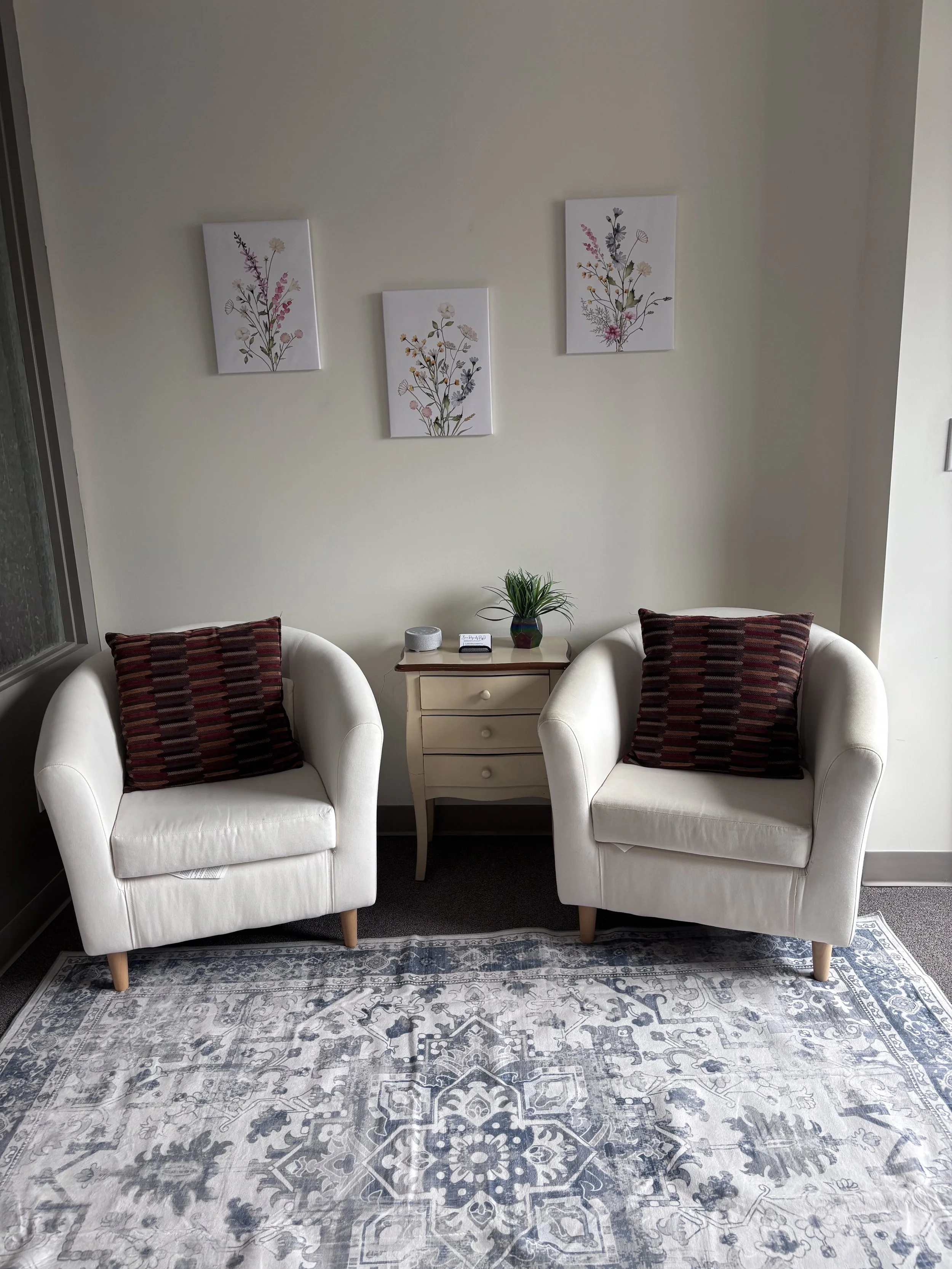 Interior of a room with a gray sofa, comfortable chairs