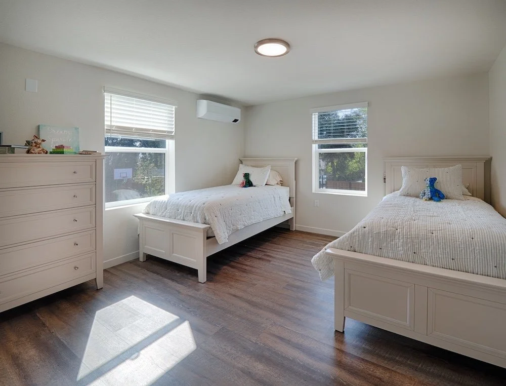 Cherry Creek Village affordable housing bedroom with air conditioning, wood floors, windows