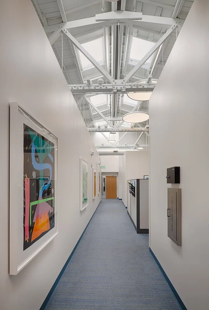 Ritter Center hallway with gallery art and open ceiling.